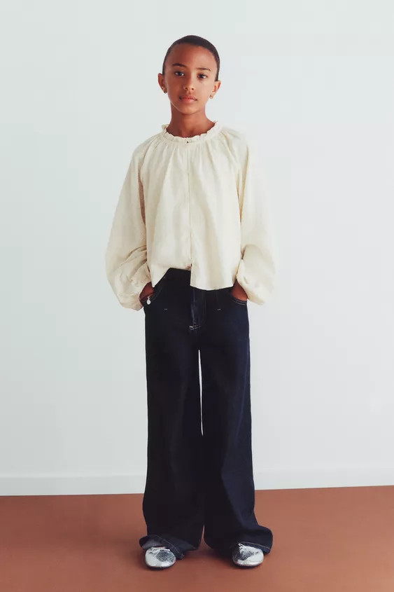 Round neck blouse with long sleeves and elastic cuffs. Front button closure. Stud appliqué. Matc... | Zara US