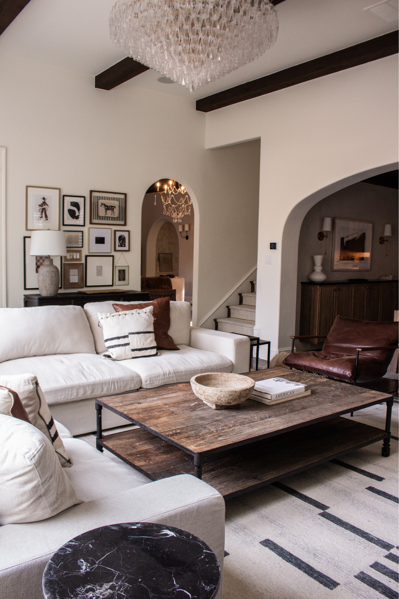 A living room that feels both polished and comfortable. The leather chair, textured rug, and layered artwork create such a beautiful, collected look.

living room styling ideas, neutral living room inspiration, leather accent chair decor, gallery wall styling, cozy home design, modern classic interiors, warm neutral palette

#LTKSeasonal #LTKHome