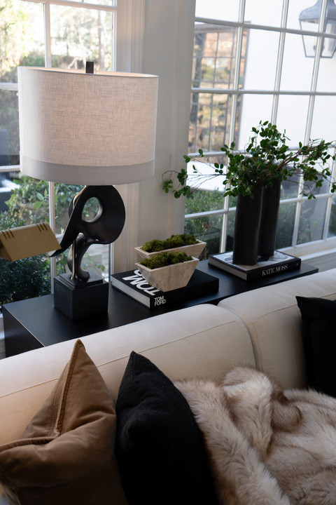 EEK this little living room nook makes me so happy!! Neutral decor, cozy throw pillows, sculptural lamp, stacked design books and fresh greenery creating the dream modern home aesthetic. The natural light is everything and the whole space feels warm, calm and beautifully styled! 

 #LTKSeasonal #LTKHome #LTKSaleAlert