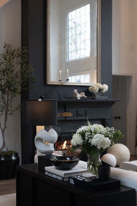 Post-Christmas living room views and I am SO obsessed! The layered black and cream palette, sculptural decor, cozy pillows, and organic greenery create the perfect modern luxury vibe. This space feels warm, elevated, and effortlessly chic, with timeless neutrals and bold contrast doing all the work. It’s the kind of interior design that feels calm yet dramatic, curated yet livable, and so perfectly classic modern for everyday luxury living. 

 #LTKSeasonal #LTKHome #LTKSaleAlert