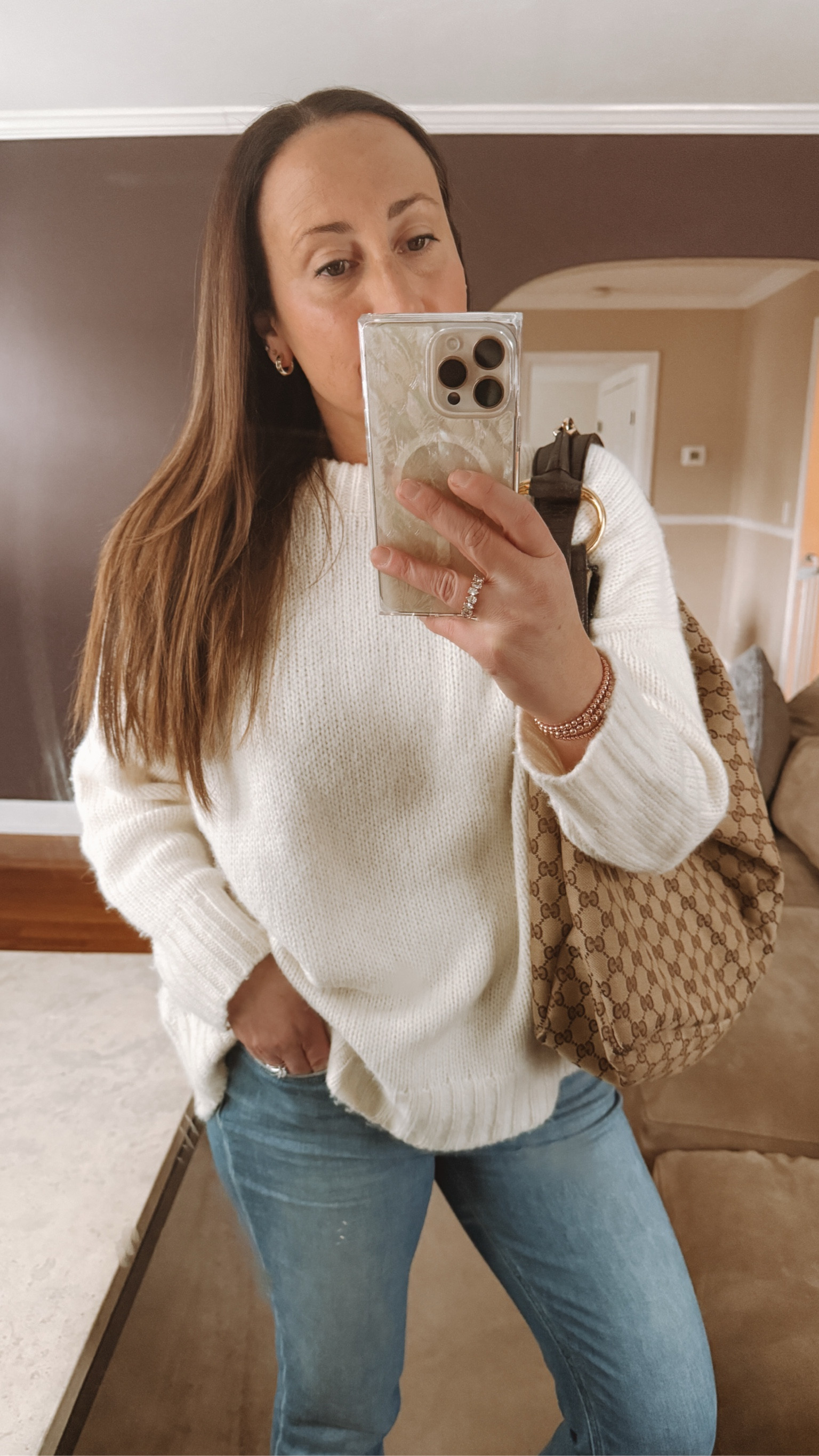 Casual winter outfit. Work outfit.  I love this sweater. It’s the softest cashmere. The neutral color goes well with any pant or skirt. It has an oversized fit too which is flattering for a casual look. //. Work wear. Winter outfit. Casual. Sweater. Boots. Handbag  

#LTKSeasonal #LTKWorkwear #LTKStyleTip