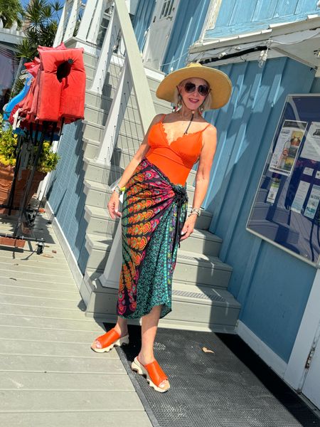Back From Bali Womens Sarong Beach Swimsuit Bikini Cover up Wrap Peacock & Clip. Comes in many cool prints. Orange swimsuit is so good and a happy and sunnies are a necessity. 
My @sorel slides are on my feet every day. They come in black and tan. 
Resort wear, one piece swimsuit, slides, sarong, swimsuit coverup

#LTKSeasonal #LTKFindsUnder50 #LTKTravel