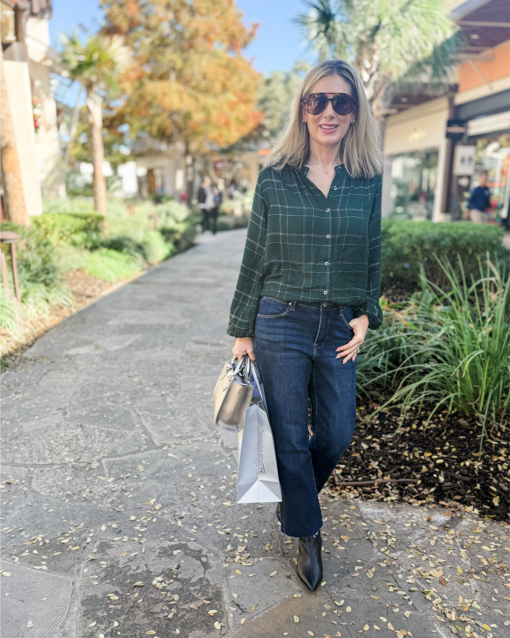Recently went to our local outdoor mall and the holiday decorations are so pretty! It also helped that it as 75° out and sunny-it was a great spot to get my steps in!! I wore this banded collar button front blouse with the prettiest silver running through it, especially when it catches the light. Paired it with one of my favorite pairs of jeans and the ankle boots I’ve been wearing on repeat! 

Fashion over 50, casual outfit, holiday outfit, dark wash jeans, Walmart fashion 

#LTKOver40 #LTKShoeCrush #LTKFindsUnder50
