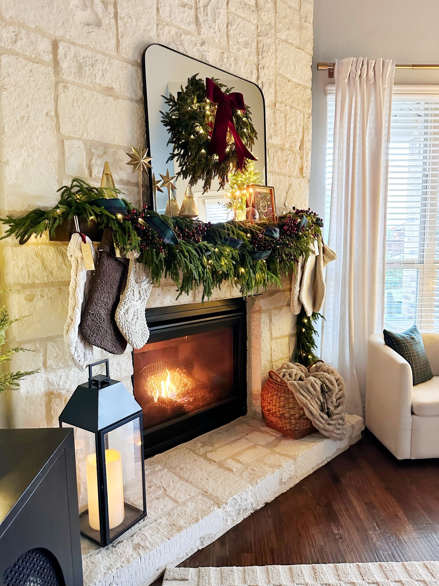 Classic holiday fireplace 🔥 garland, plaid ribbon, and a wreath that ties it all together. simple, timeless, and perfectly festive. 🎄

#LTKHome #LTKFamily #LTKHoliday