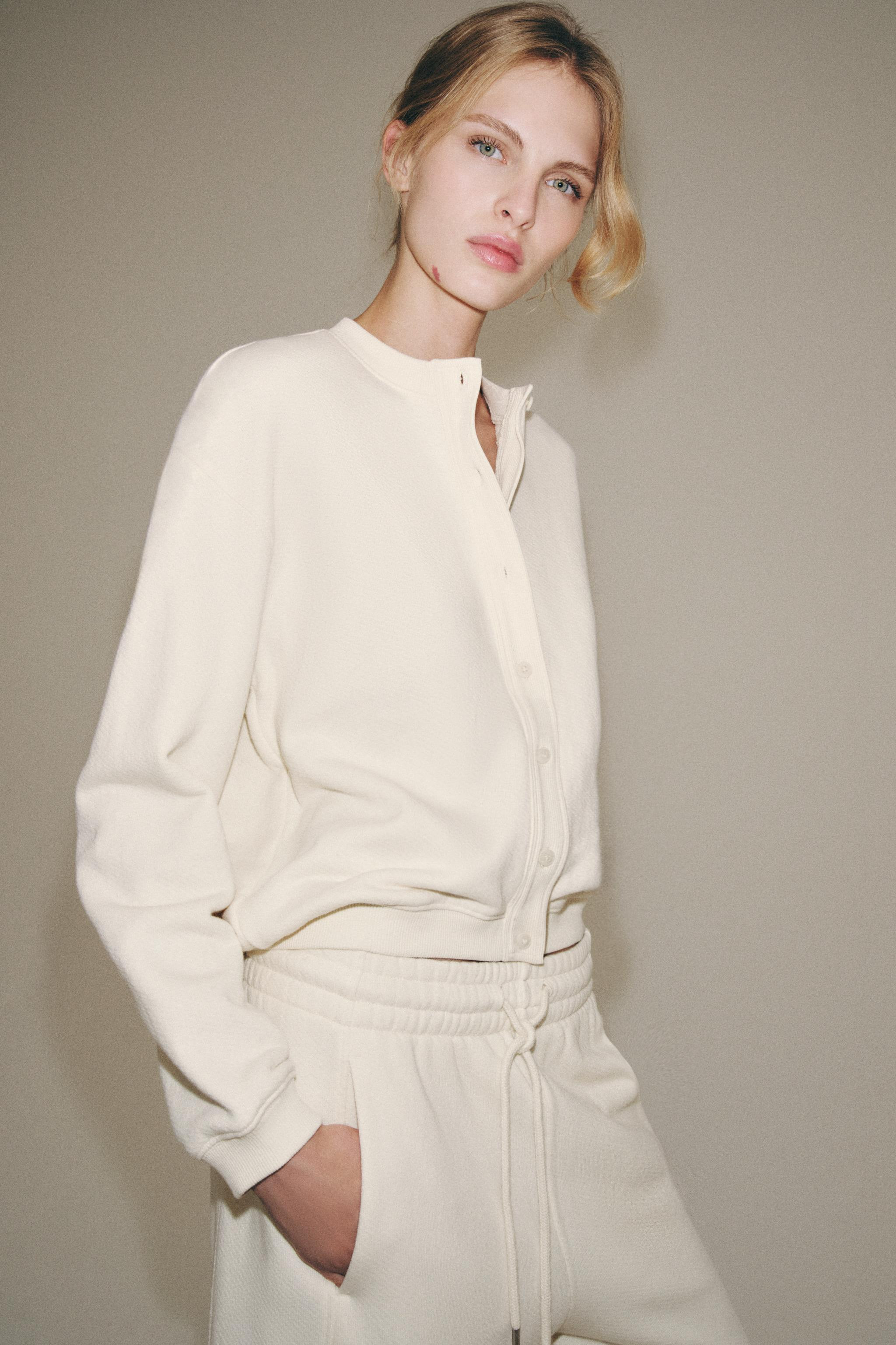 Sweatshirt made from cotton yarn. Round neck, long sleeves with cuffs. Asymmetric hem. Front butt... | Zara US