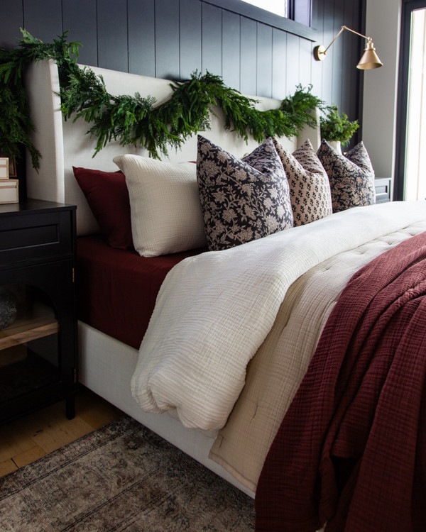 This is my favorite holiday bedding look yet — soft neutral duvet, rich burgundy…