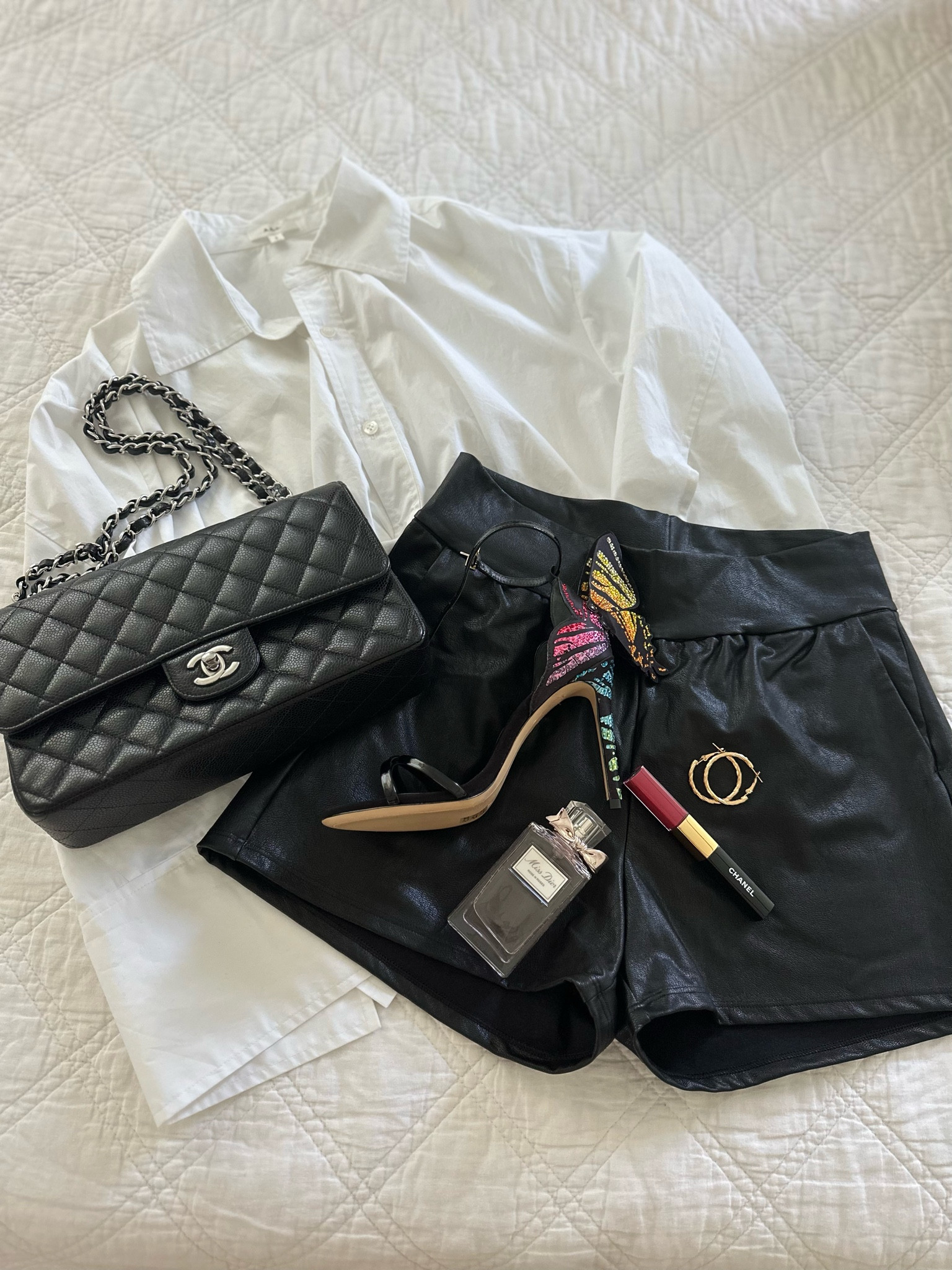 Pair faux leather shorts with a white button down shirt and fun heels for a night out look! Date night look, Girls night out look

Commando faux leather shorts, A.L.C. Button down shirt, Sophia Webster butterfly heels, Chanel double flap bag, gold hoop earrings, Dior perfume, Chanel lipgloss 

#LTKstyletip #LTKshoecrush #LTKitbag