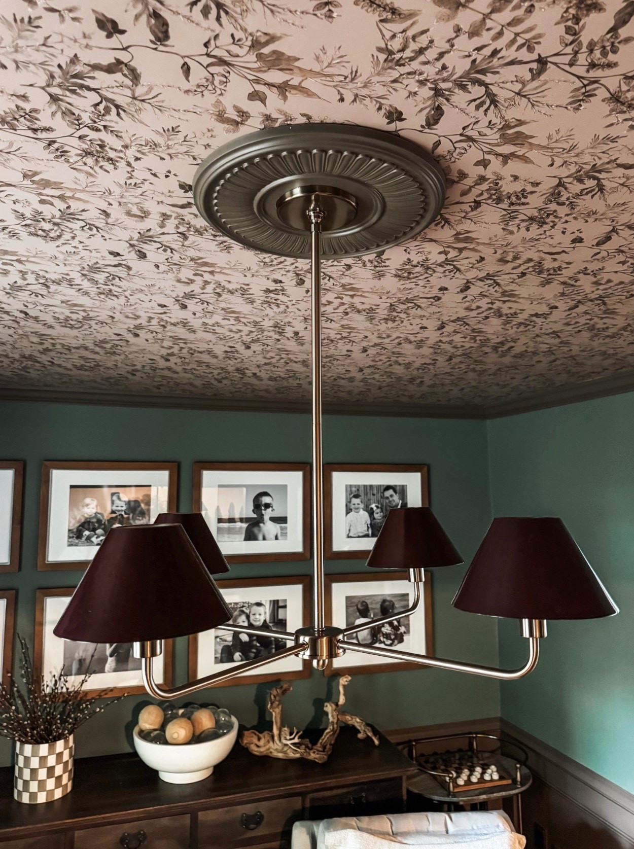 This classic ceiling light fixture instantly elevates the room ✨ Featuring a traditional chandelier with brass finish, tapered fabric lampshades, and a detailed decorative ceiling medallion, this lighting moment pairs beautifully with botanical wallpaper, moody green walls, and vintage-inspired framed artwork. A perfect example of layered traditional home decor that feels warm, timeless, and collected.

#eanesinteriors #chandelier #ceilinglight #classiclighting #traditionaldecor #vintagestyle #brasslighting #lampshades #ceilingmedallion #botanicalwallpaper #wallpaperedceiling #gallerywall #homeinspo #interiordesign #classicinteriors

#LTKHome #LTKOver40 #LTKSeasonal