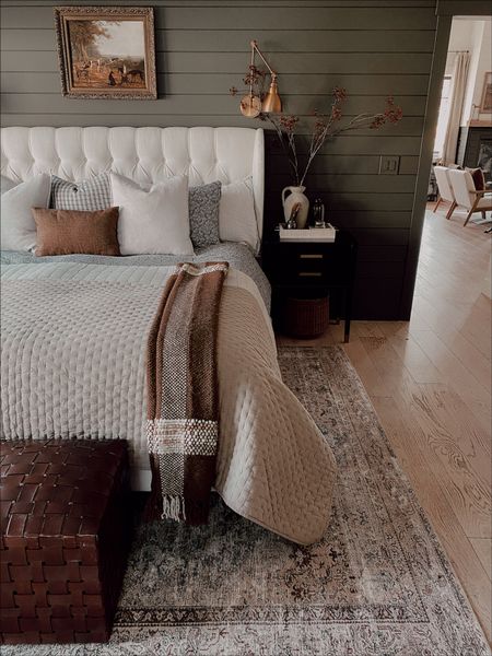Master Bedroom | ottomans, cozy rug, quilted bedding, swing arm brass light, black nightstand, cozy Fall throw, armchair, tufted linen bed, curtains

#LTKhome #LTKsalealert #LTKSeasonal