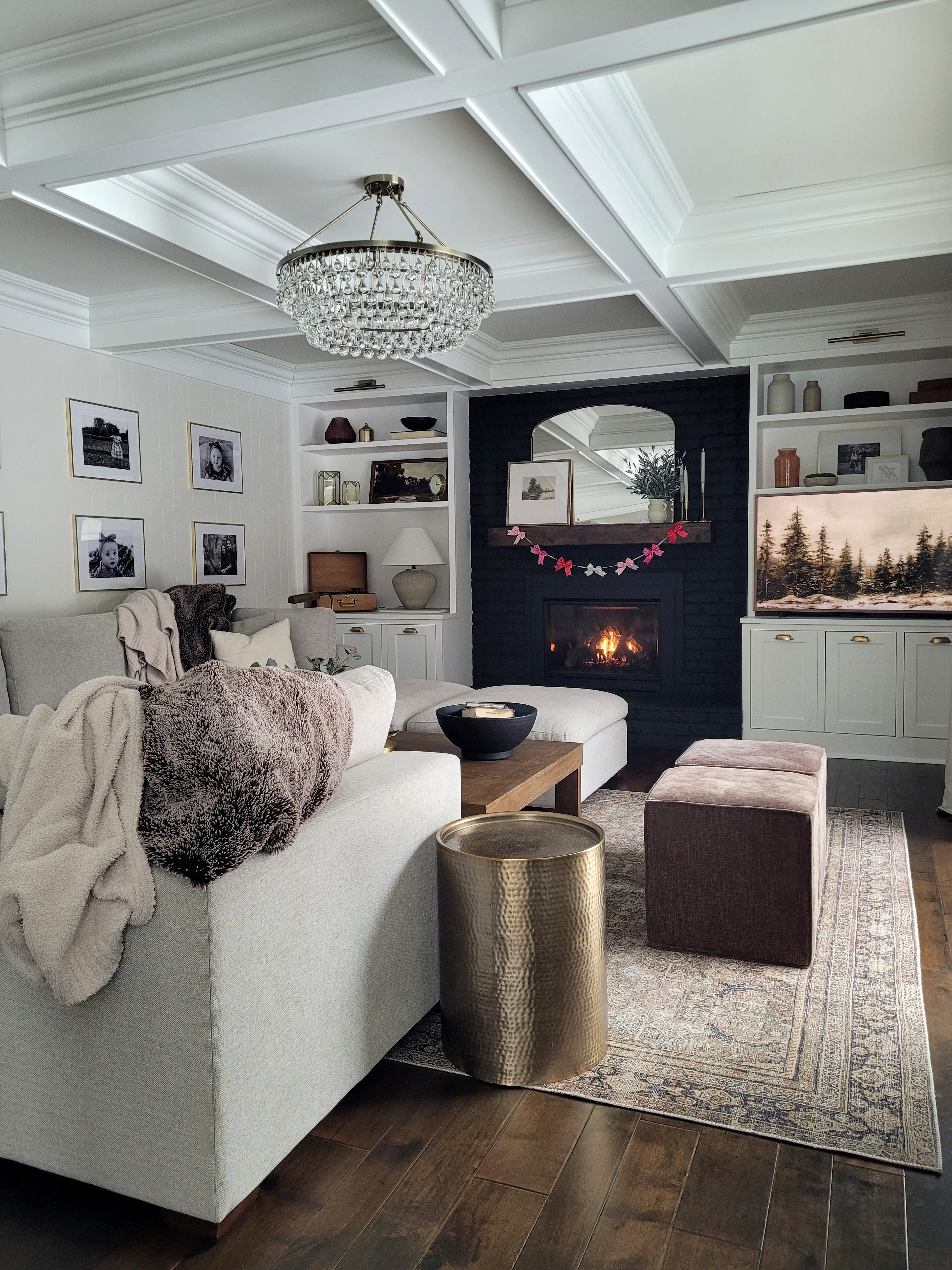 Valentine's Day living room inspo - the sweetest bow garland for your valentine's fireplace mantle decor. Built ins,  shelf styling,  coffee table,  cube ottoman,  sectional sofa,  back fireplace, coffered ceiling

#LTKValentine #LTKHome