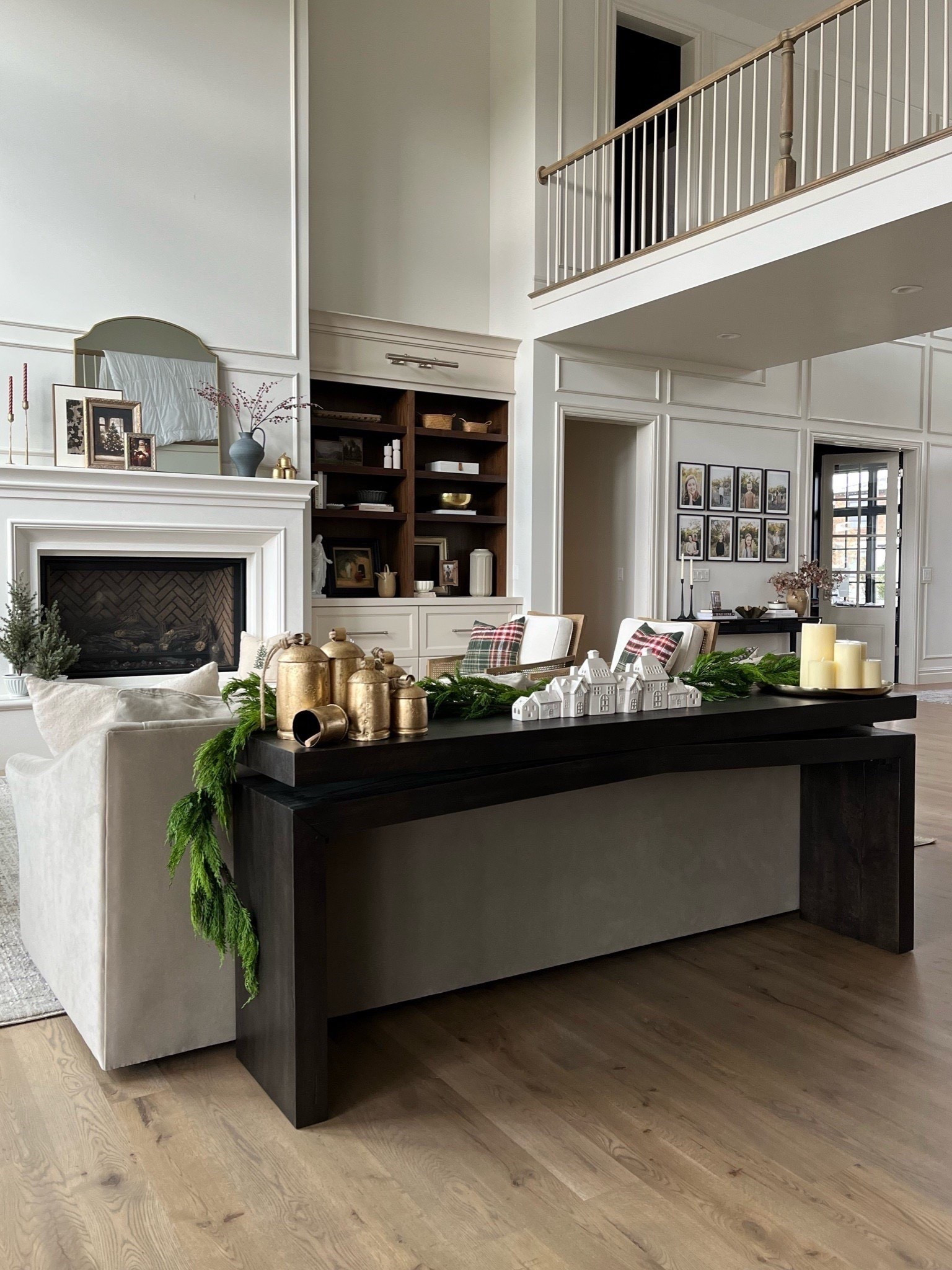 Holiday decor from Wayfair: brass bells, cedar garland, Christmas village with LED lights, pillar candles from Creative Co-Op, gold tray, all on the prettiest console table.

#LTKHome #LTKHoliday #LTKSeasonal

#LTKHoliday #LTKHome