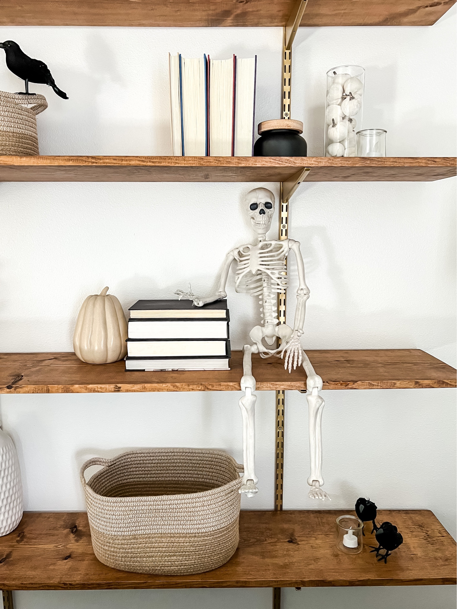 Halloween shelf styling idea! Mix Halloween decorations with everyday objects like books and baskets for a simple holiday look you won’t get tired of. 

#LTKHoliday #LTKfindsunder50 #LTKHalloween