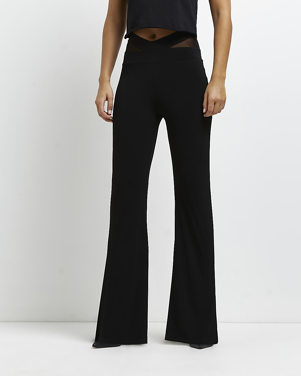 Black mesh detail flared trousers | River Island (UK & IE)