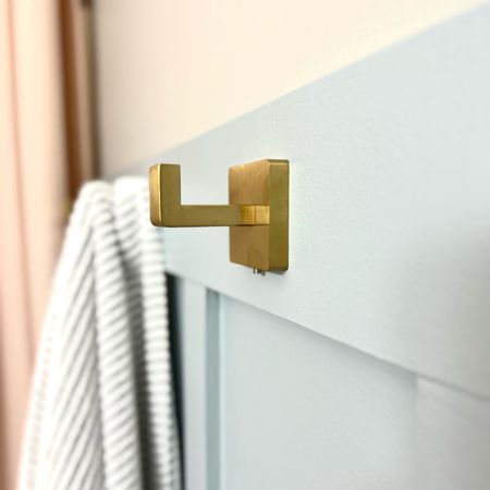 Loving our modern gold towel hook for our bathroom board and batten wall. #goldbathroomfixtures #brasshooks #towelhooks #bathroomdecor 

#LTKhome