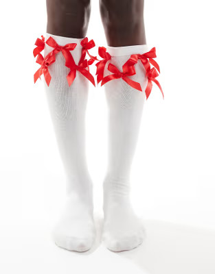 Reclaimed Vintage knee-high socks with red bows in white | ASOS (Global)