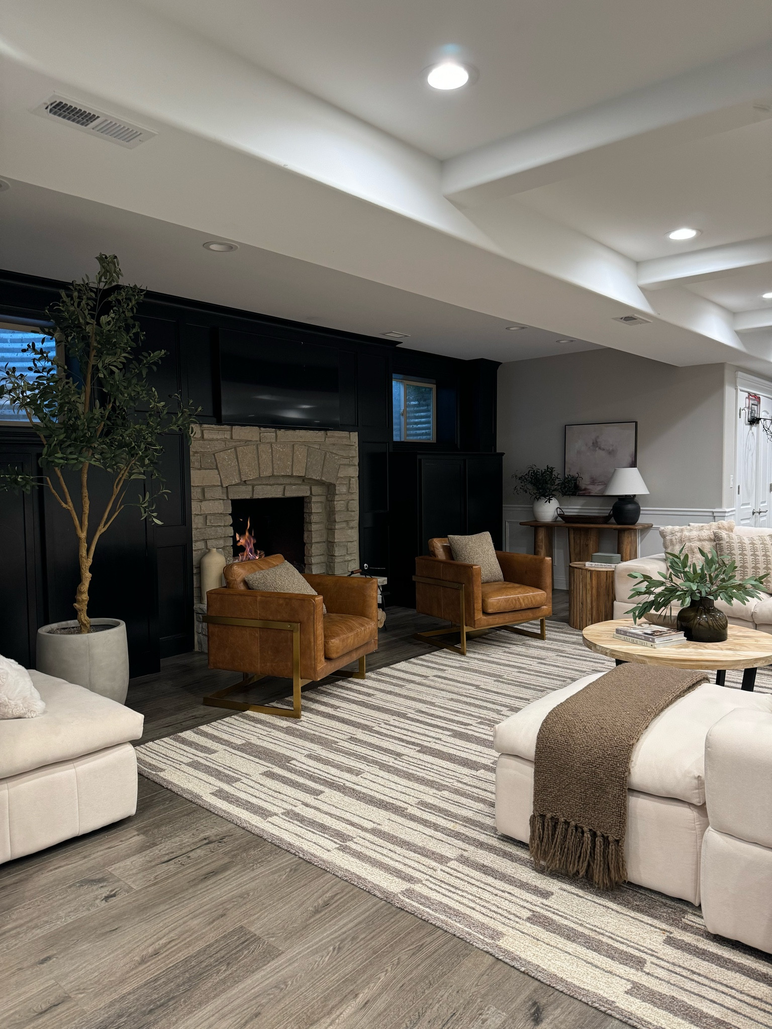 Basement cozy views! Chairs are Edloe and Finch, and coffee table is from Article and cannot be linked. Rug is on sale, and my faux olive tree and favorite designer inspired planter. 

#LTKSaleAlert #LTKSummerSales #LTKHome