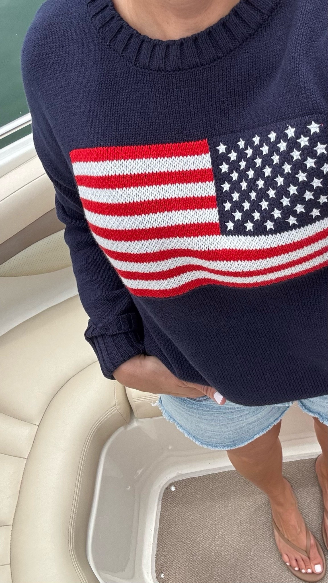 Women’s American flag sweater. High rise cut off denim shorts. Tkees neutral flip flop sandal.