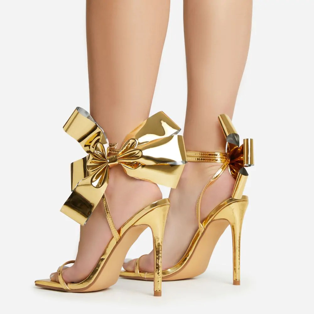 Beau Oversized Bow Detail Square Toe Stiletto Heel In Gold Faux Leather | EGO (UK)