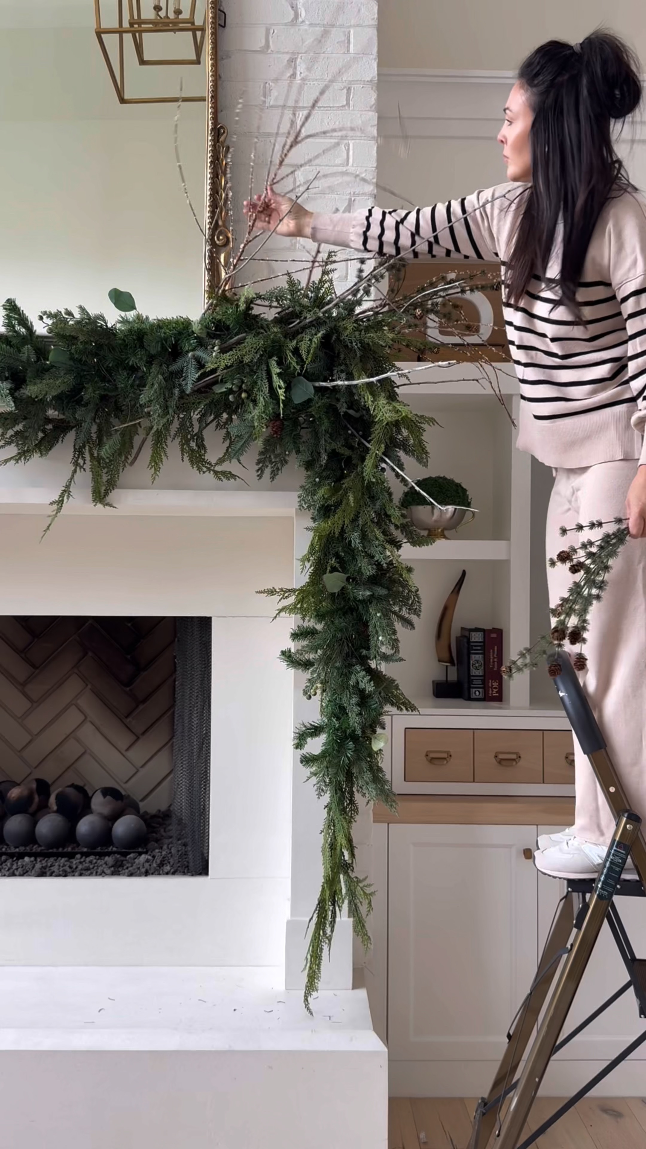 Creating a whimsical woodland garland for my mantel. My mantel is 7ft tall and 5ft wide for reference. 
Here is what I used:
 1 strand of multi green garland 9ft
(On sale + free shipping)
1 strand faux cedar 9ft
1 strand of these twinkle lights
5 faux pincone picks
5 frosted branch picks
Actual branches and deer sheds I found on my property. 
My fav flameless candles remote control operated. 

#LTKHoliday #LTKSeasonal #LTKSaleAlert