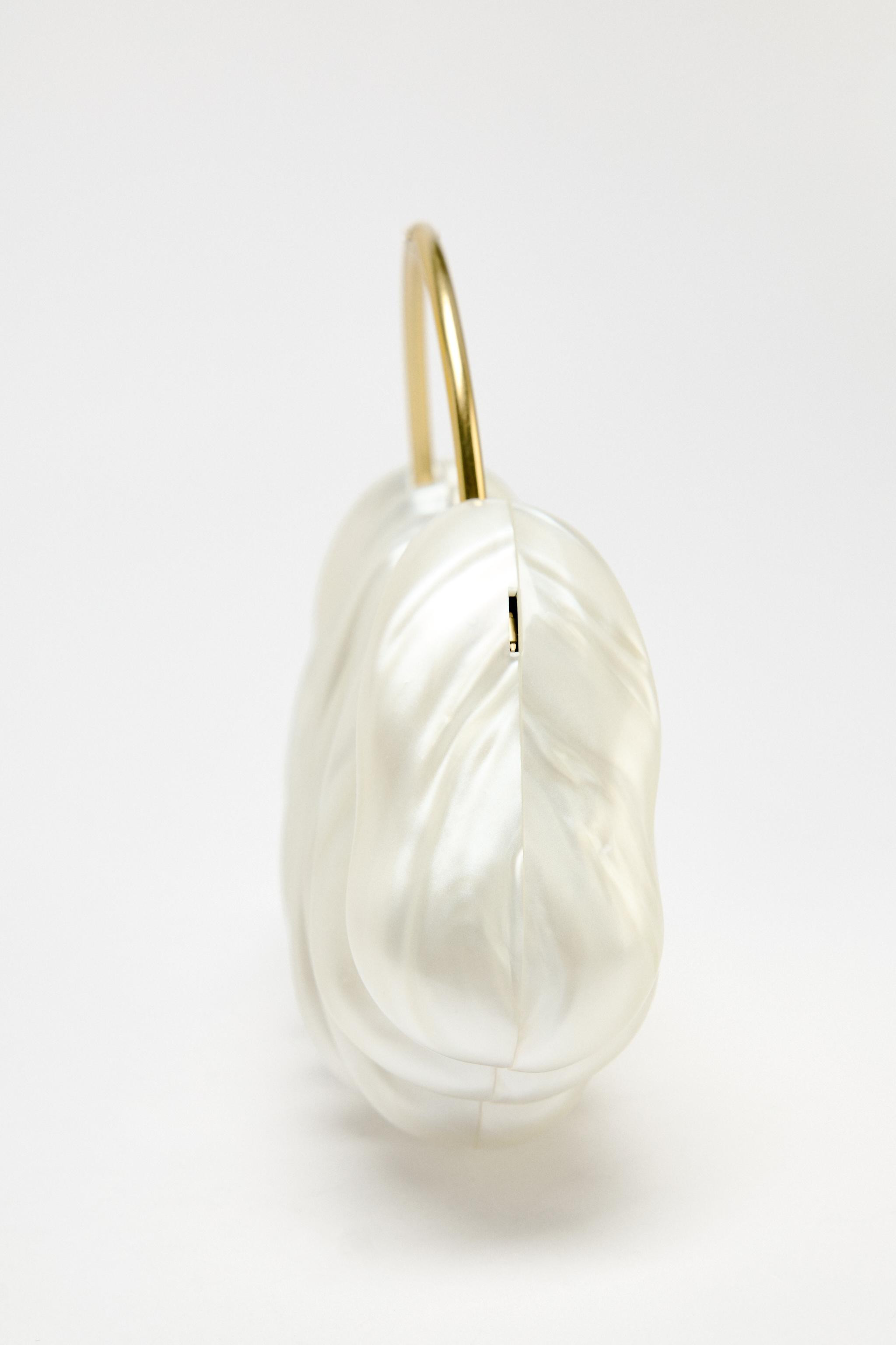 Asymmetric pearl effect clutch bag. Metallic rigid top handle. Removable chain strap. Magnetic cl... | Zara UK