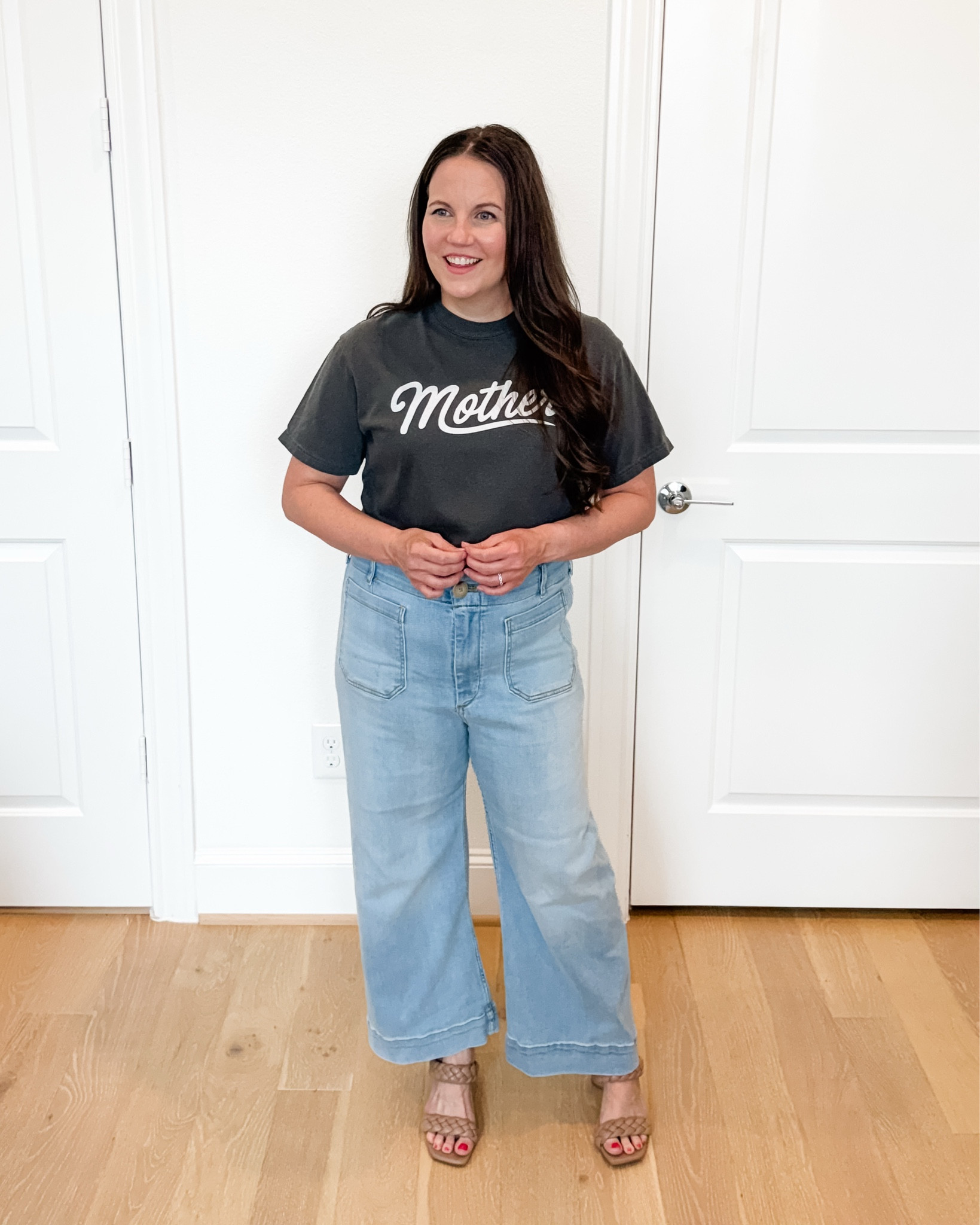 This casual chic and easy mom outfit pairs a dark gray mother graphic tee with light wash flared jeans and braided sandals for a look that feels comfortable, elevated, and effortless. These jeans with stretch are incredibly flattering and perfect for everyday wear, while the graphic tee is one of my favorite mom shirts for adding personality to a simple outfit. Whether you’re heading out for lunch, running errands, traveling, or packing a vacation outfit, this classic combination is a staple for creating stylish summer outfits you’ll wear on repeat.

#LTKmomlife #LTKOver40 #LTKSeasonal