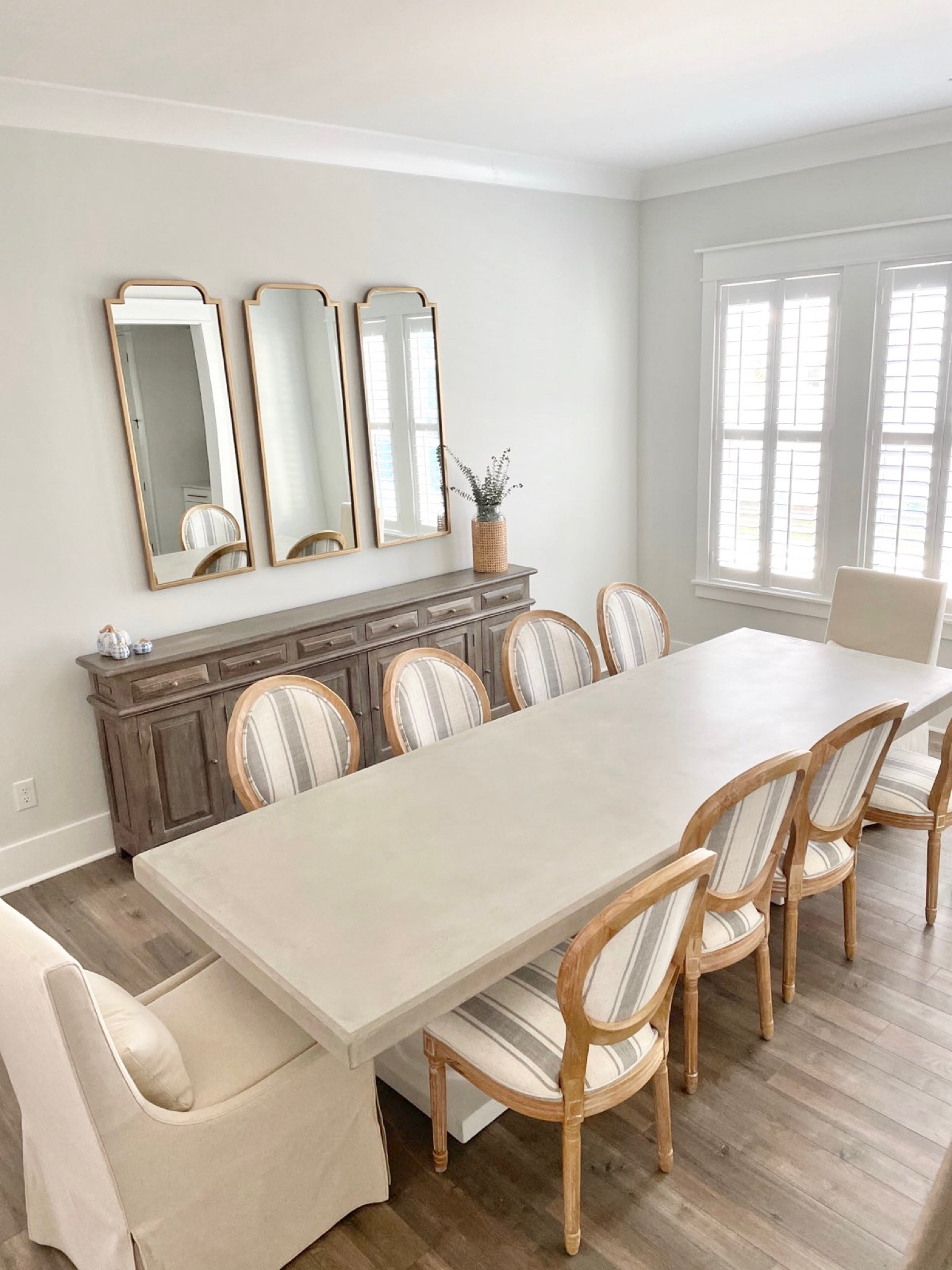 Coastal dining room table Linen striped dining chairs Gold mirrors Dining room decor Dining chairs Upholstered dining chairs 

#LTKhome #LTKstyletip