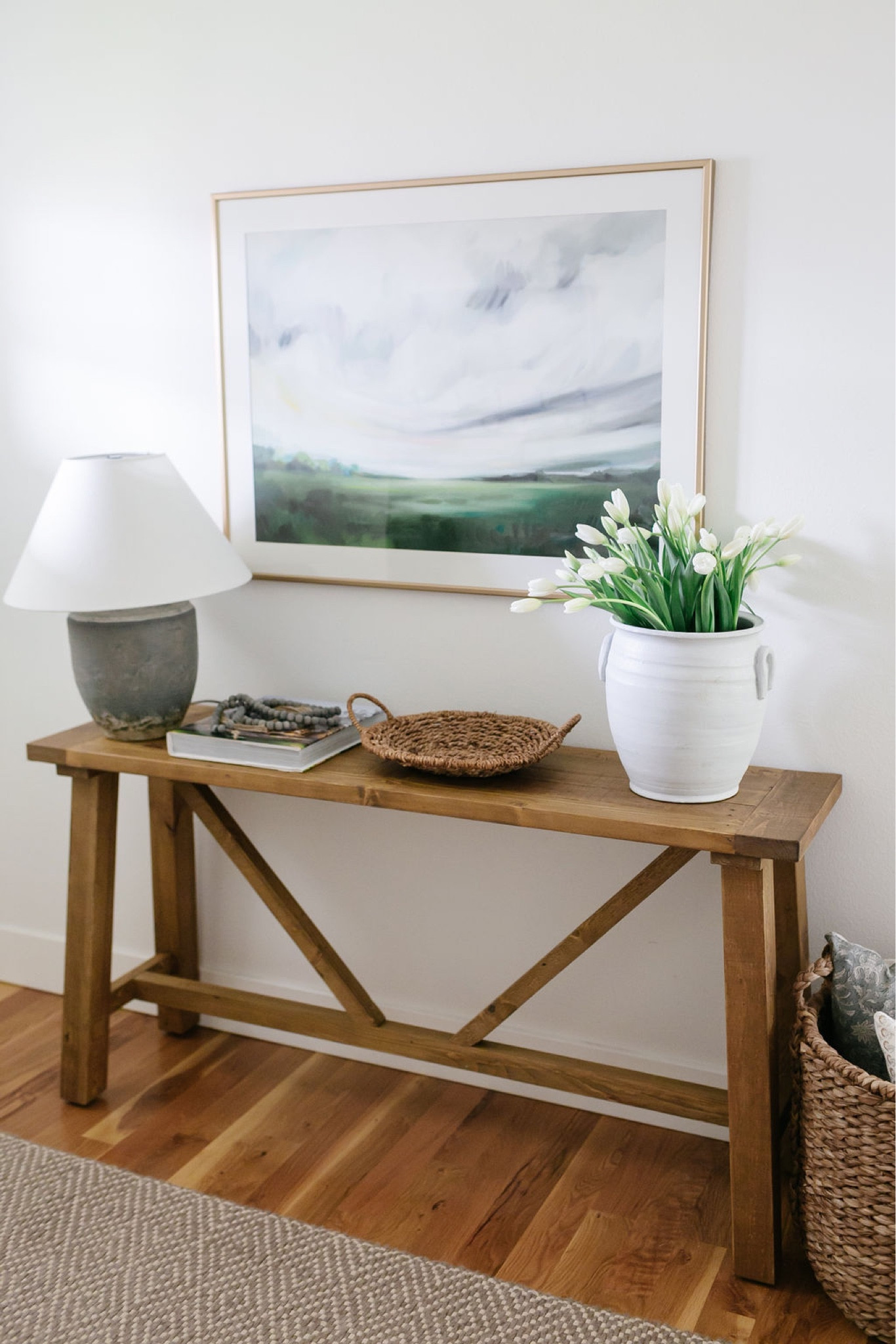 In my entryway I have a wood console table, landscape artwork, a large vase filled with tulips and a table lamp. 

#LTKFind #LTKhome #LTKstyletip