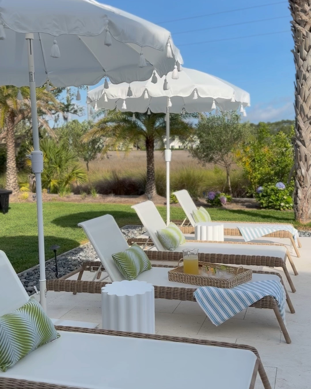 our little poolside refresh is finally coming together and these @wayfair finds have been some of my favorite additions for summer ☀️
the umbrellas instantly elevated the whole space. they’re made with Sunbrella fabric, have the prettiest coastal-inspired tassel detailing, and feel so high-end without the designer price tag. we paired them with our Business & Pleasure umbrella bases with casters and love how sturdy and functional they are.
i also can’t get over all the smaller styling pieces that make everything feel layered and finished — the scalloped accent tables, palm-trim pillows, striped Turkish towels, and the Juliska serving pieces we’ve been using nonstop for poolside drinks and snacks. the acrylic pitcher and tumblers are especially chic while still being practical for outdoor entertaining.
such a fun mix of elevated but easy pieces for summer hosting and slow afternoons by the pool ☀️

#AD #WayfairPartner #Wayfair

#LTKSeasonal #LTKSaleAlert #LTKHome