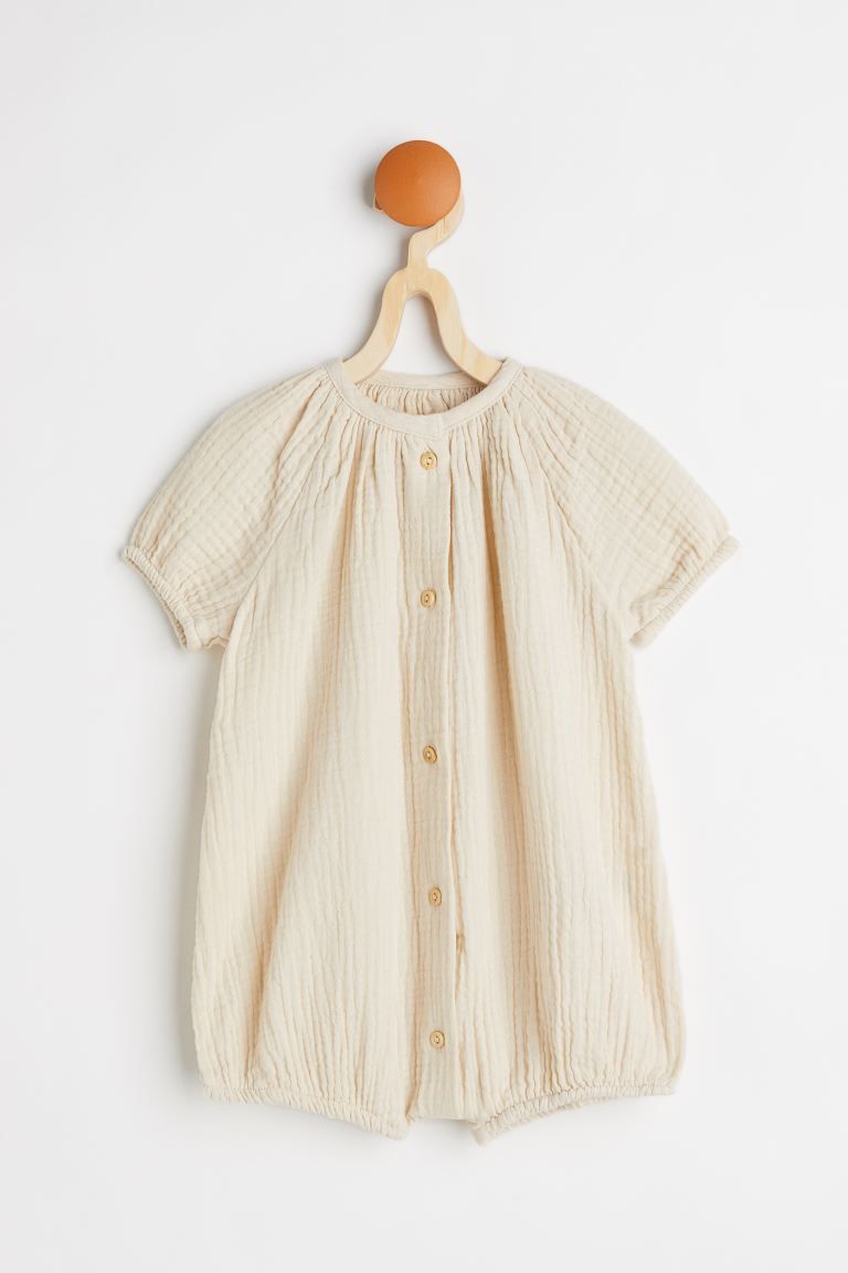 Baby Exclusive. Short-sleeved romper suit in airy, woven cotton fabric. Buttons at front and shor... | H&M (US)