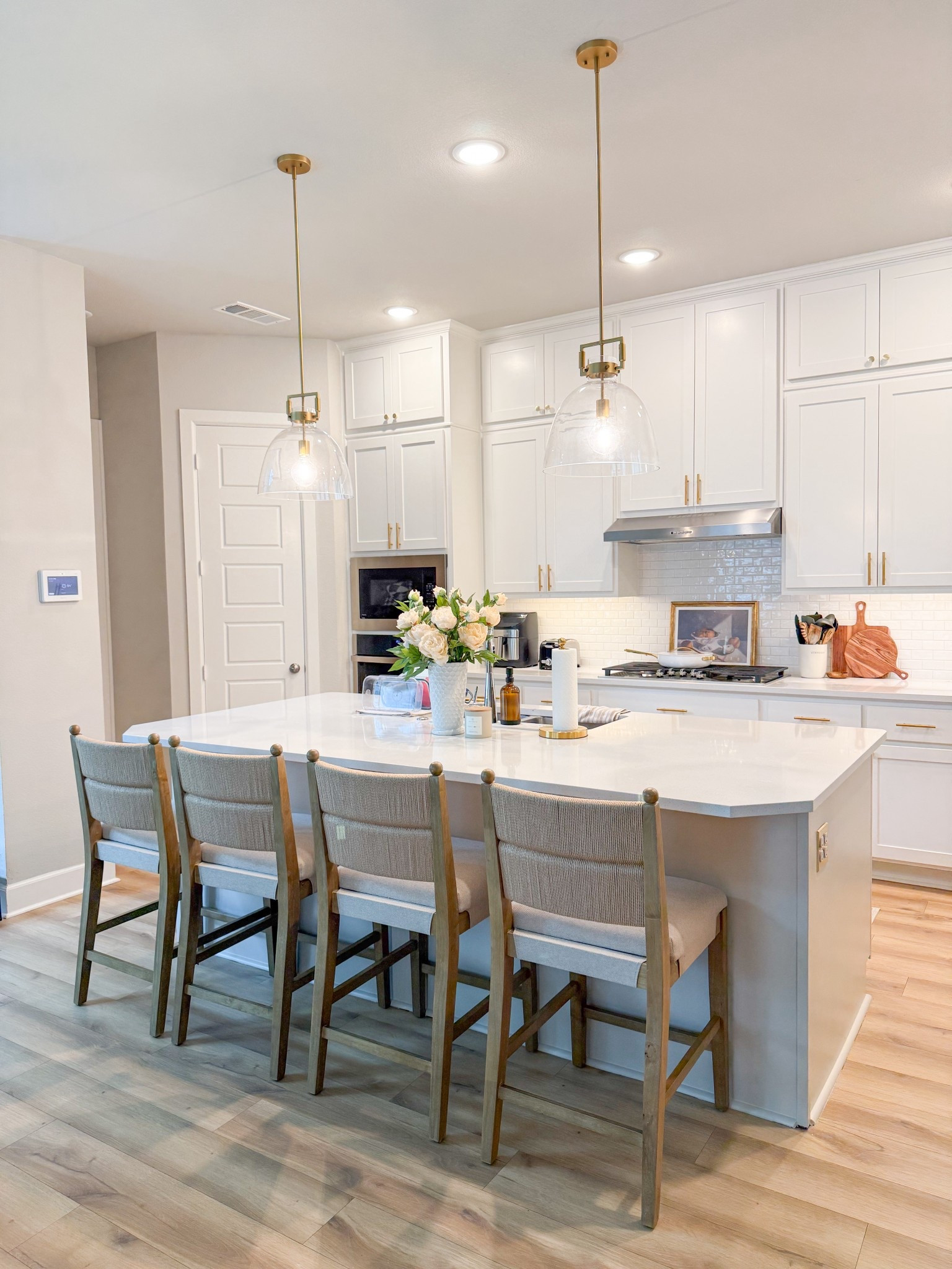 final kitchen revamp reveal!! new paint, new hardware, pendant lights & these dreamy seagrass barstools! ✨ 



#LTKHome