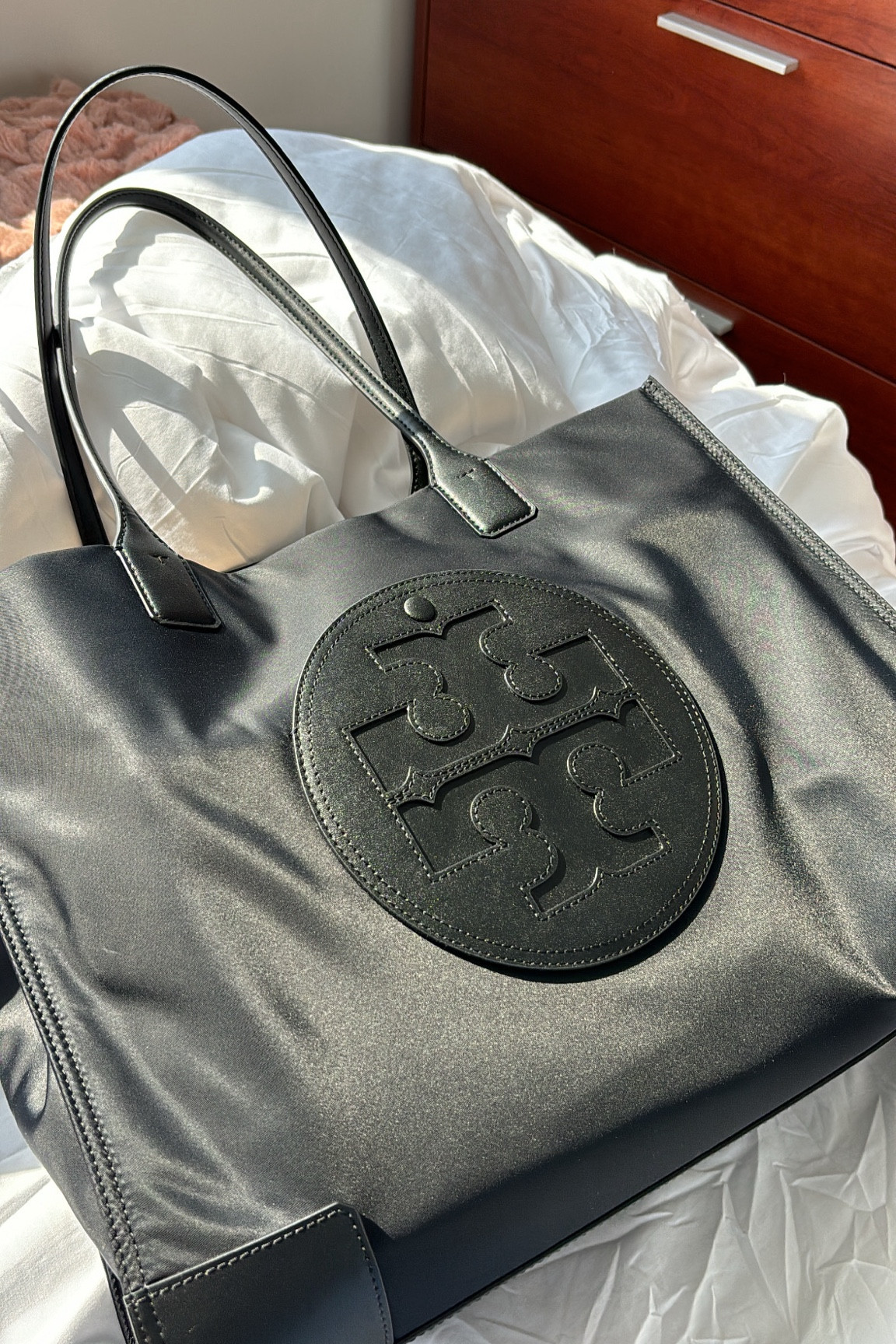 Tory Burch tote 

A nice alternative to all of the long champ bags now of days. You can get 15% off if you sign up with a new email! 

It has a pouch that can fit a laptop. I have a 15 inch and it doesn’t fit but a 13 and maybe a 14 can fit in there. I keep my iPad in there. It has snap closures on the sides and a magnetic closure for the top middle. There’s also a small zipper pouch and the logo in the front is a pocket itself. The straps are really comfortable for the amount I carry: 15 inch Mac book, iPad, water bottle, planner, 2 pouches 

School tote . Work tote . Nylon bag . Nylon tote . Laptop tote . Tory Burch bag . Tory Burch tote 

#LTKItBag #LTKBacktoSchool #LTKWorkwear
