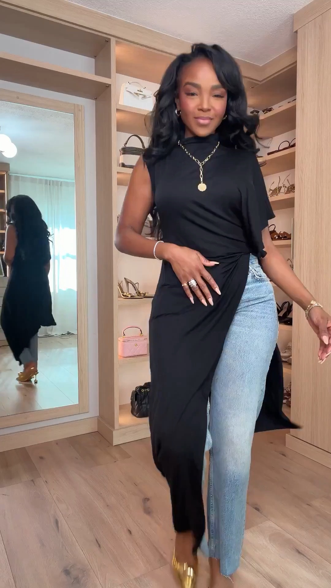 Hi Babes!

This outfit is proof that basics don't have to be boring. The dramatic black asymmetrical top paired with relaxed straight-leg denim creates the perfect high-low mix of elevated and effortless. Add the statement gold heels and suddenly this simple denim look feels fashion-forward, expensive, and completely unforgettable.

If you're petite and curvy, this look is incredibly flattering because the flowy asymmetrical silhouette adds movement while the structured denim keeps everything balanced. The open-back detail makes this outfit feel special without trying too hard.

Where to wear this:
• Date nights
• Girls night out
• Dinner reservations
• Fashion events
• Concerts
• Vacation evenings
• Birthday celebrations
• Rooftop cocktails

Undergarments: Adhesive bra or nipple covers for the cleanest look with the open-back design.

Everything is linked below.

xx Kira | IG: KirasFashionFinds

34D - 27 - 40 • Size Small or 4

Follow me on Instagram and YouTube @kirasfashionfinds