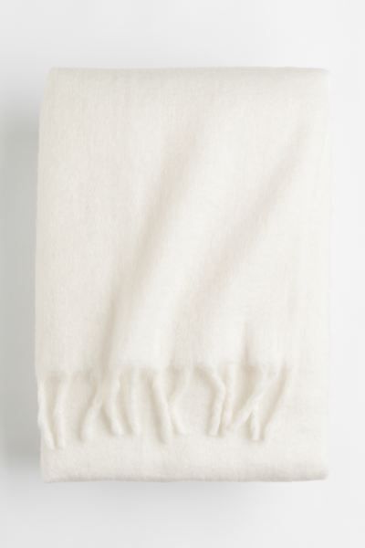 Soft throw in double layers of woven fabric with wool content and a brushed finish. Large fringe ... | H&M (US + CA)