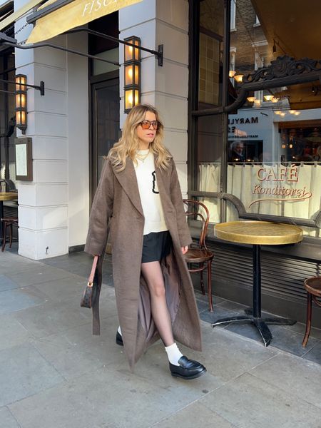 Hailey Bieber inspired outfit - Brown weekday long coat teamed with a cream jumper, black mini skirt & loafers 



#LTKeurope #LTKstyletip