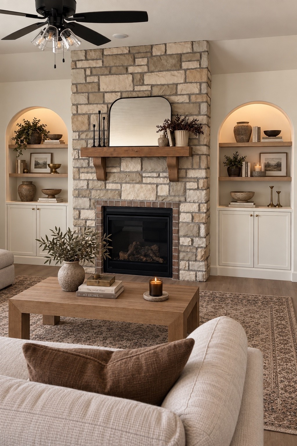 A warm and collected living room moment 🤎 I paired arched built-ins with layered decor, integrated lighting, a vintage-inspired rug, rich brown tones and warm wood accents for an elevated, transitional look.

#LTKHome