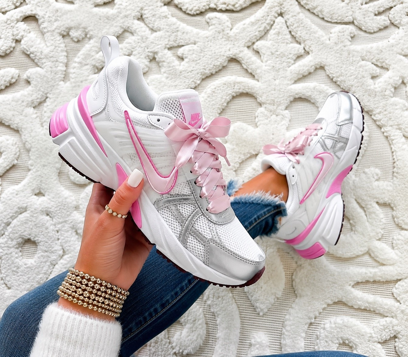 Nike V2K Run. These are giving the prettiest sporty girl vibes. 💗 The silver reflective details paired with the soft pink accents make them the perfect everyday sneaker to elevate any athleisure look. They’re lightweight, super comfortable, and easy to style with leggings, denim, or your favorite matching set.

Fit: Runs true to size. If you’re between sizes or prefer a little extra room, you may want to go up a half size.