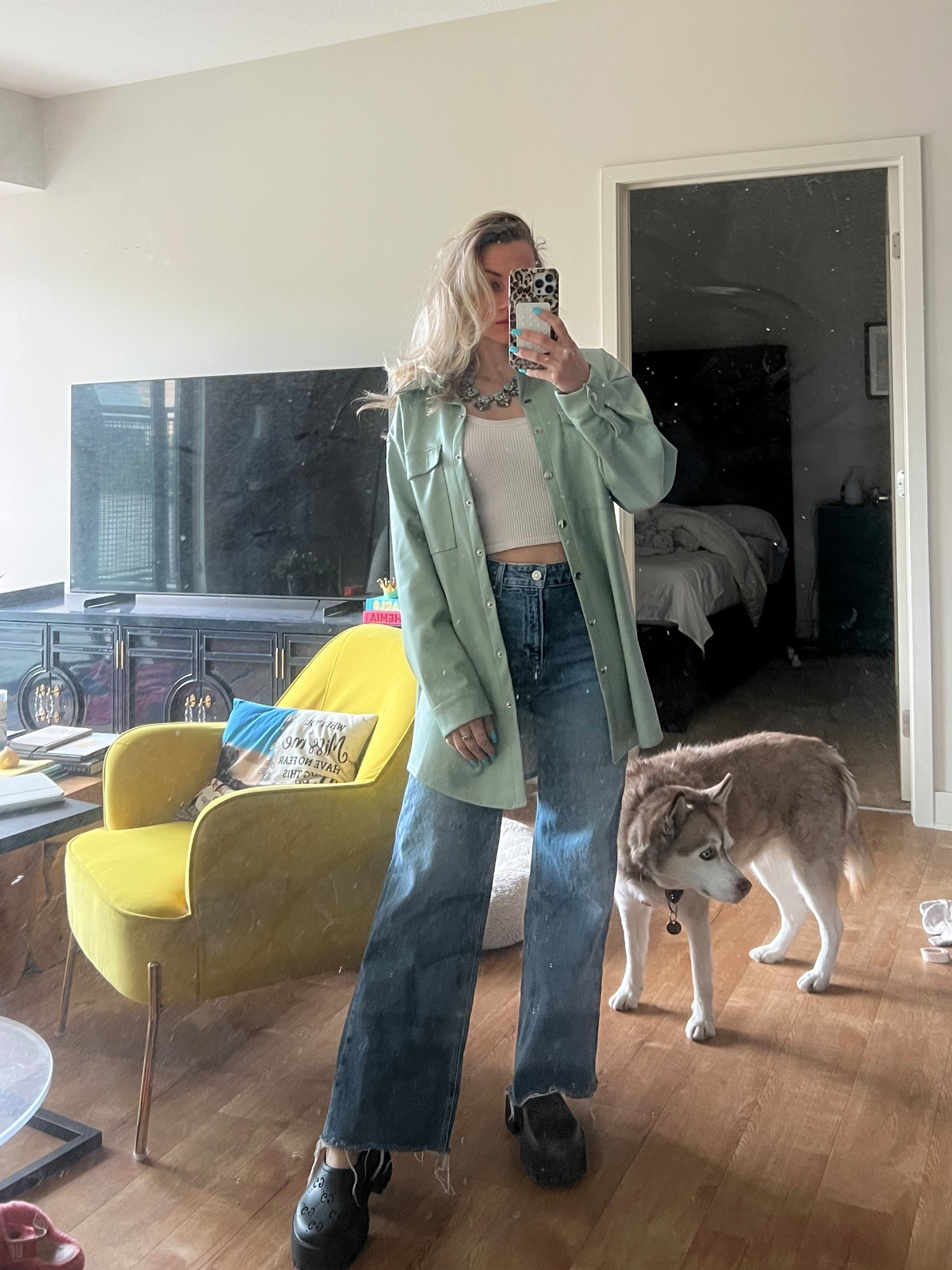 Chunky mules, wide leg jeans layered with a leather shirt jacket is all in this look!