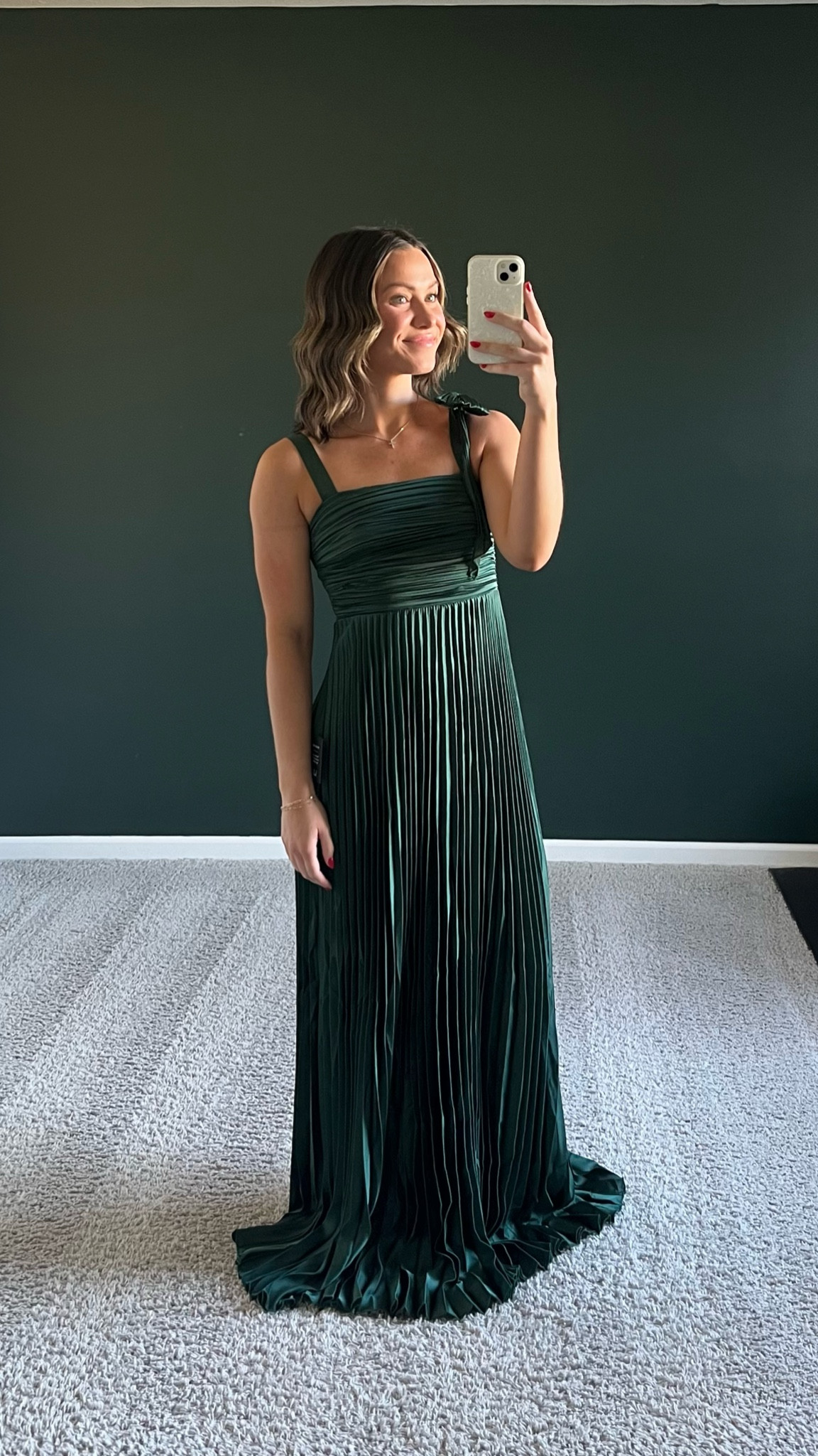 10/10 dress. Beautiful bow detail on one shoulder. Pleating looks so chic and the overall quality looks and feels like it should cost way more than $100. Very tight in chest area, would size up if you have an average to large chest. I’m wearing a small (32/34A bra size) and it’s snug. Not wearing heels in this pic. 5’5” tall and the dress is pooling at the bottom. Great length to add heels or to accommodate someone taller!

#LTKSeasonal #LTKFindsUnder100 #LTKWedding