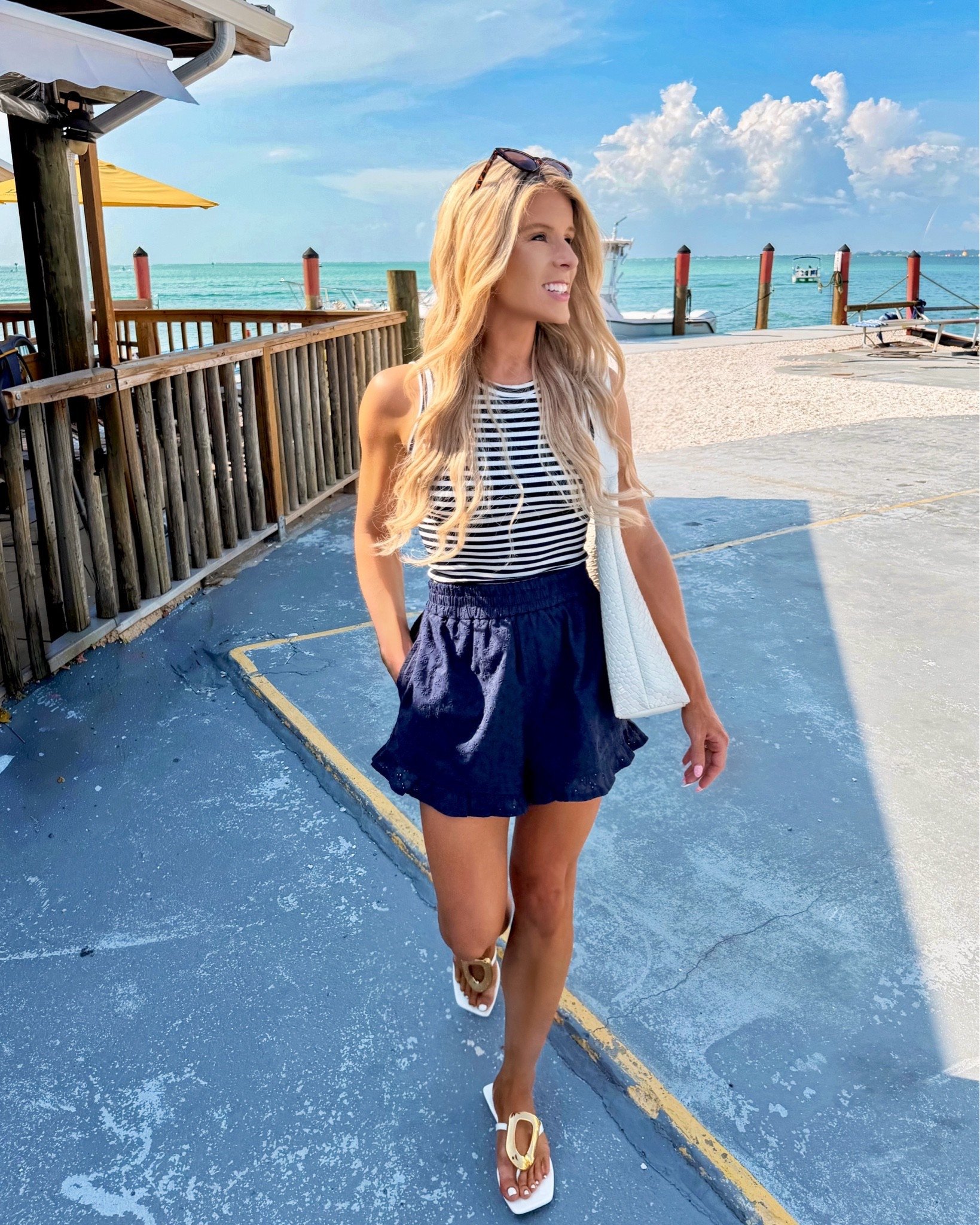 Coastal summer outfit / vacation outfit on SALE! I styled this white + navy striped tank top with matching highwaisted eyelet shorts that have a ruffle hem.  

Navy shorts, pull on shorts, coastal outfit, beach vacation outfit, nautical outfit, boat outfit, Fourth of July outfit, patriotic outfit

#LTKSaleAlert #LTKootd #LTKSeasonal