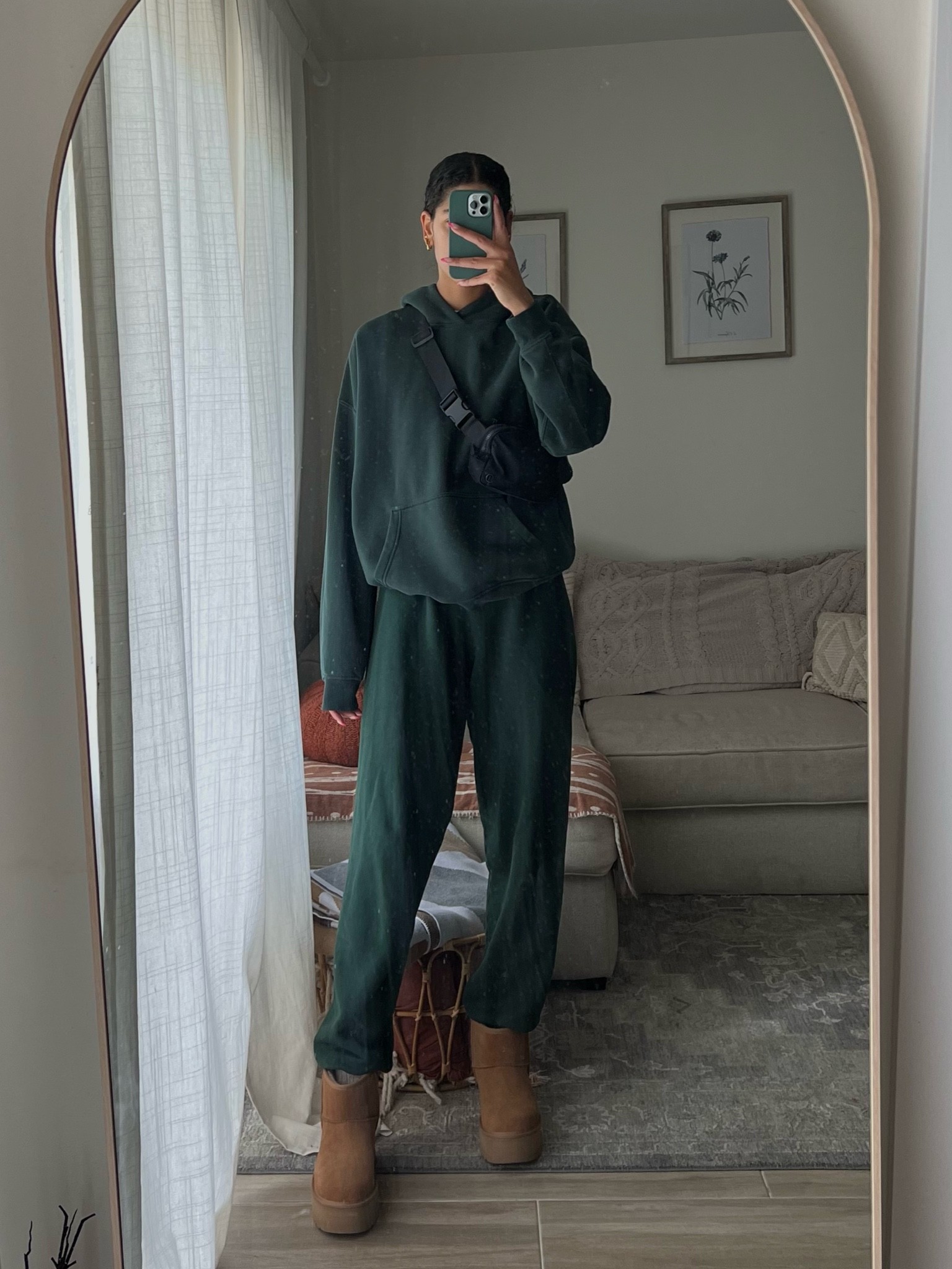 sweatpants: Joah brown 
Forest green plain hoodie: Abercrombie (size large) 
Mini platform Ugg’s (size down full size ) 
Lulu lemon crossbody everyday belt bag 