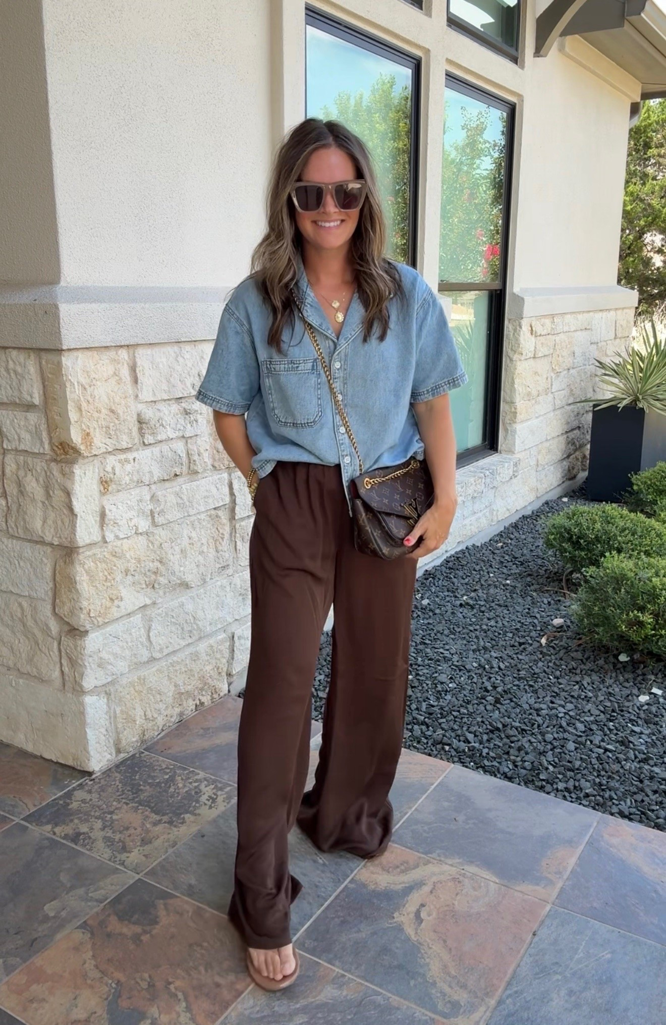 This whole outfit is exactly how I want to dress for fall. Denim + chocolate brown with easy sandals and a crossbody just WORKS.

fall outfit, chocolate brown pants, denim top, casual fall outfit, brown outfit, wide leg pants, fall sandals, crossbody bag, denim and brown, warm fall outfit, everyday fall style, JulieFranks