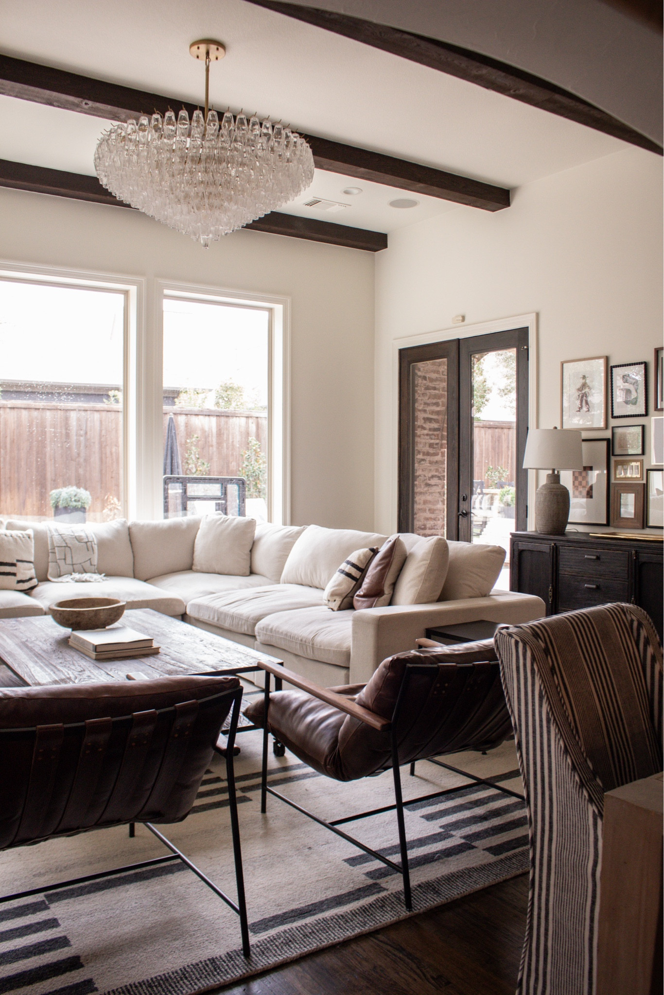 Minimal but warm living room design. Neutral sectional, wide media cabinet, layered textures, and mixed materials. Organic modern home decor ideas.

#LTKHome #LTKSeasonal