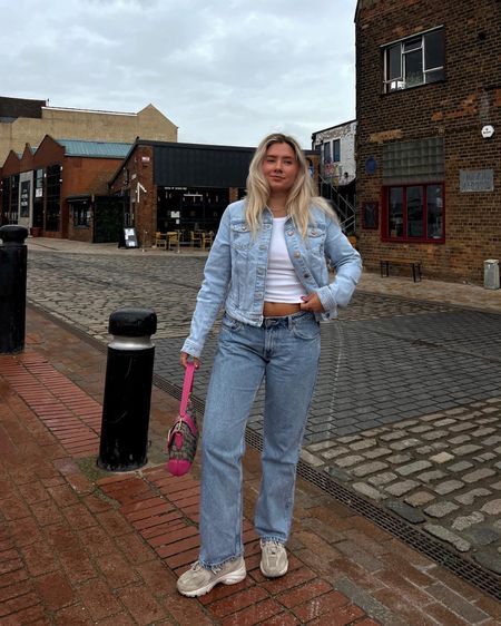 double denim look with a cropped light blue jacket, low rise straight leg jeans, chunky new balance 530 trainers, pink coach soho shoulder bag and white tank top

#LTKstyletip #LTKshoecrush #LTKeurope