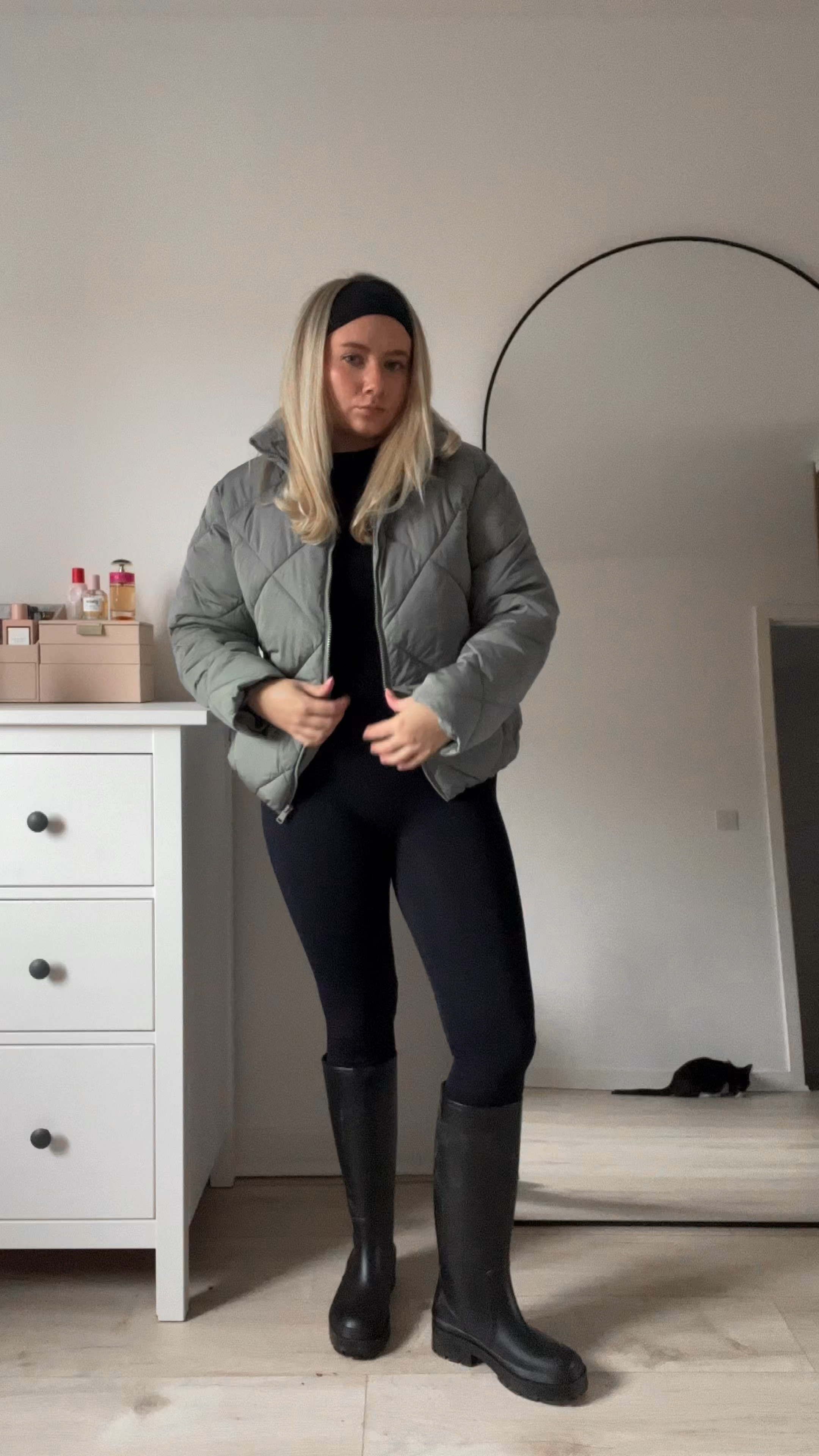 cosy winter walk outfit featuring a seamless ribbed unitard/jumpsuit, a black rib knit long sleeve jumper, black knee high flat boots/wellies, a khaki quilted puffer jacket, a headband and a prada re-edition crossbody nylon bag 🖤

#LTKSeasonal #LTKstyletip #LTKeurope