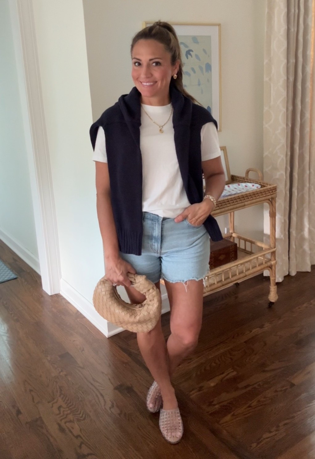 Women’s American flag sweater. Cut off denim shorts. Jelly clear slides. Jelly sandals. Knot woven handbag.