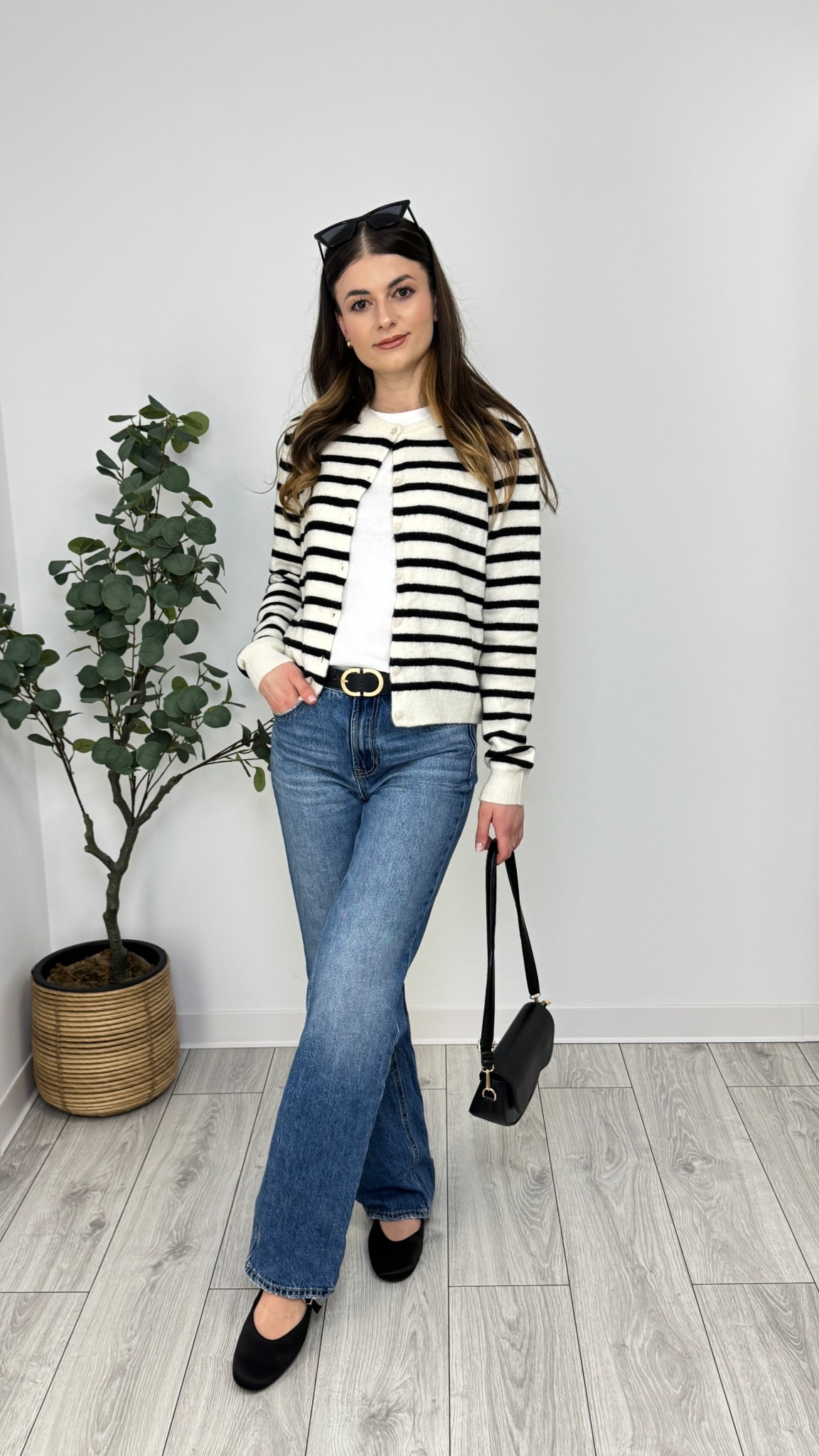 A striped cardigan over a white tee and wide-leg jeans creates a timeless, casual elegance. Black ballerina flats and a sleek purse complete the effortlessly chic look 🦋 #IlaStylesDiary 

#LTKeurope #LTKworkwear #LTKspring