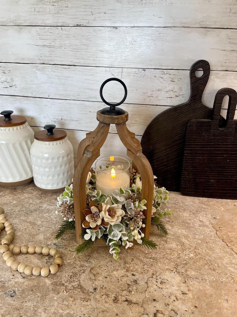 Cozy winter charm meets handcrafted elegance with this stunning sola wood flower lantern centerpiece from AllBoutiqueThings 🤍 Designed in a beautiful open wood lantern, this limited-quantity piece features natural sola wood flowers, frosted eucalyptus, and optional spruce stems for a soft, seasonal look. Finished on all sides and sized perfectly for a flameless candle or small vase, it makes a statement on entry tables, mantels, or dining spaces. With custom color options and glowing five-star reviews, this is a timeless winter décor piece you’ll love bringing out year after year.

#LTKhome #WinterDecor #SolaFlowers #LanternDecor #SeasonalCenterpiece #HandcraftedDecor #EtsyHome #CozyHome

#LTKSeasonal #LTKHoliday #LTKHome