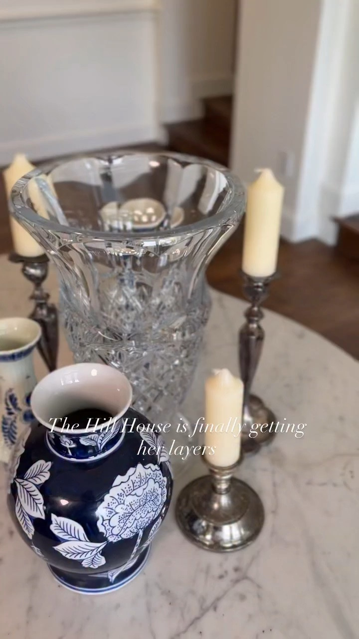 Styling the Hill House foyer table with blue and white porcelain, silver candlesticks, and magnolia stems in a crystal vase. Sharing the stems, vase, and similar pieces to recreate the look.

#LTKhome #LTKfinds #LTKhomeinspo