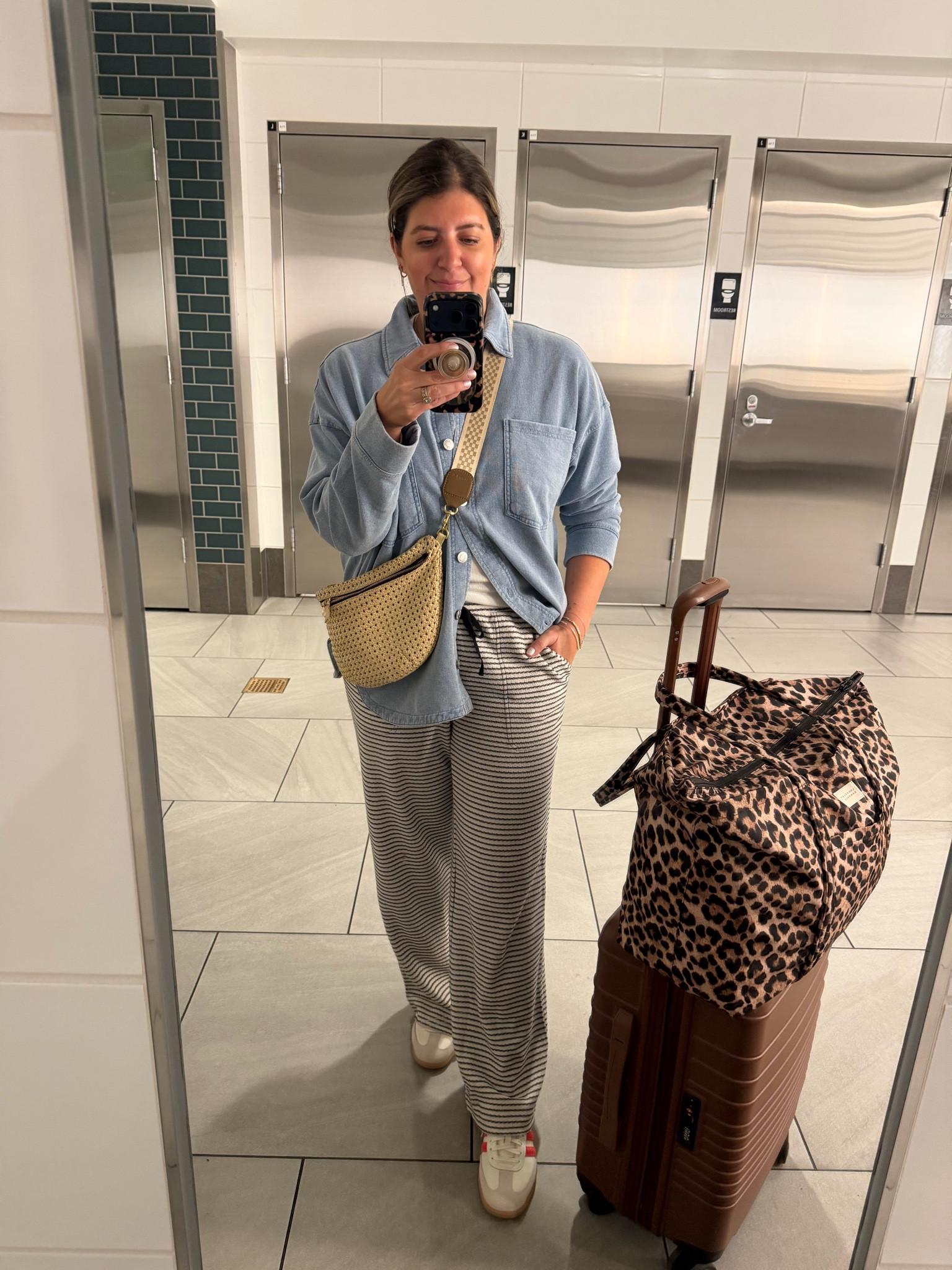 Airport OOTD in the most comfy pants and denim shirt jacket. Leopard travel bag fits so much and slides onto your roller bag! 

Size up one in jacket for a more revised fit. Lounge pants run TTS. 

#LTKMidsize #LTKootd #LTKTravel