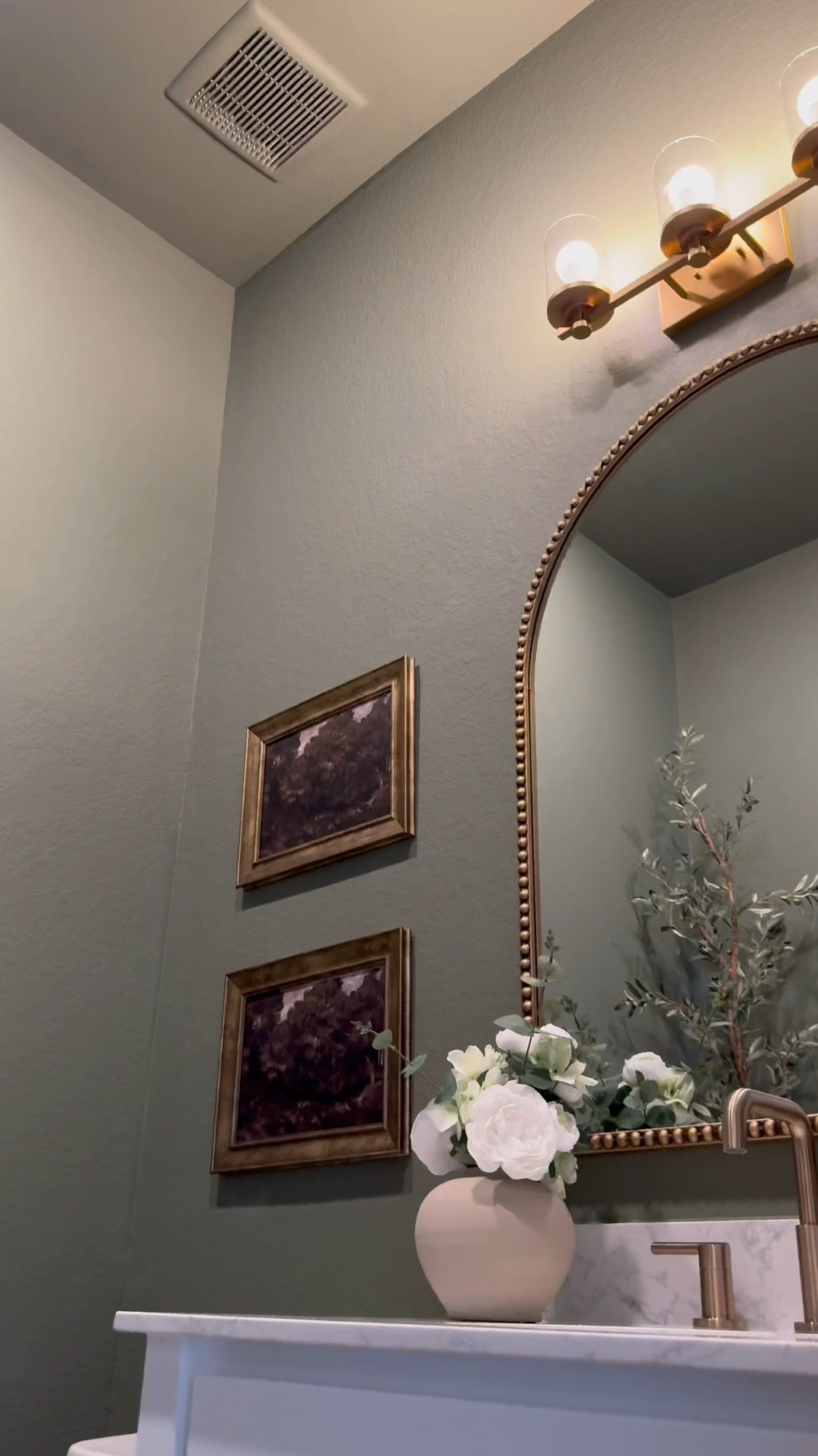 If you’re considering color drenching a room green, I’m telling you, THIS might be the perfect color for you … go for it! 🤍

Walls & Ceiling - flat finish
Baseboards - satin finish

I was apprehensive but I decided to paint the ceiling 😬 …. Surprisingly it made the room feel larger! 

I chose brass finishes to create a vintage feel…, modern vintage perhaps …??? 😆.. 

The mirror is 30x40 inches… 

I added a new light fixture and it now faces upward … which makes that wall feel taller!

I wasn’t in love with this builder grade vanity tbh😆, matter-fact, I wanted to change it… it wasn’t functional …but now i wanna keep it lol 😂… I added brass hardware, cute baskets, led light strips on the bottom and now it’s a whole new unit….. you can even add battery powered/rechargeable/plug in led light strips .. whatever fits your lifestyle 

Ok let’s talk about this stunning planter!!! …. We all love an olive tree don’t we? 😆 … and I wanted something tall and slim… this planter was… perfect plus it added to the moody feeling of the room 🥰

#bathroommakeover #powderroom #powderroomdesign #homedecorideas #beforeafter

#LTKSaleAlert #LTKStyleTip #LTKHome